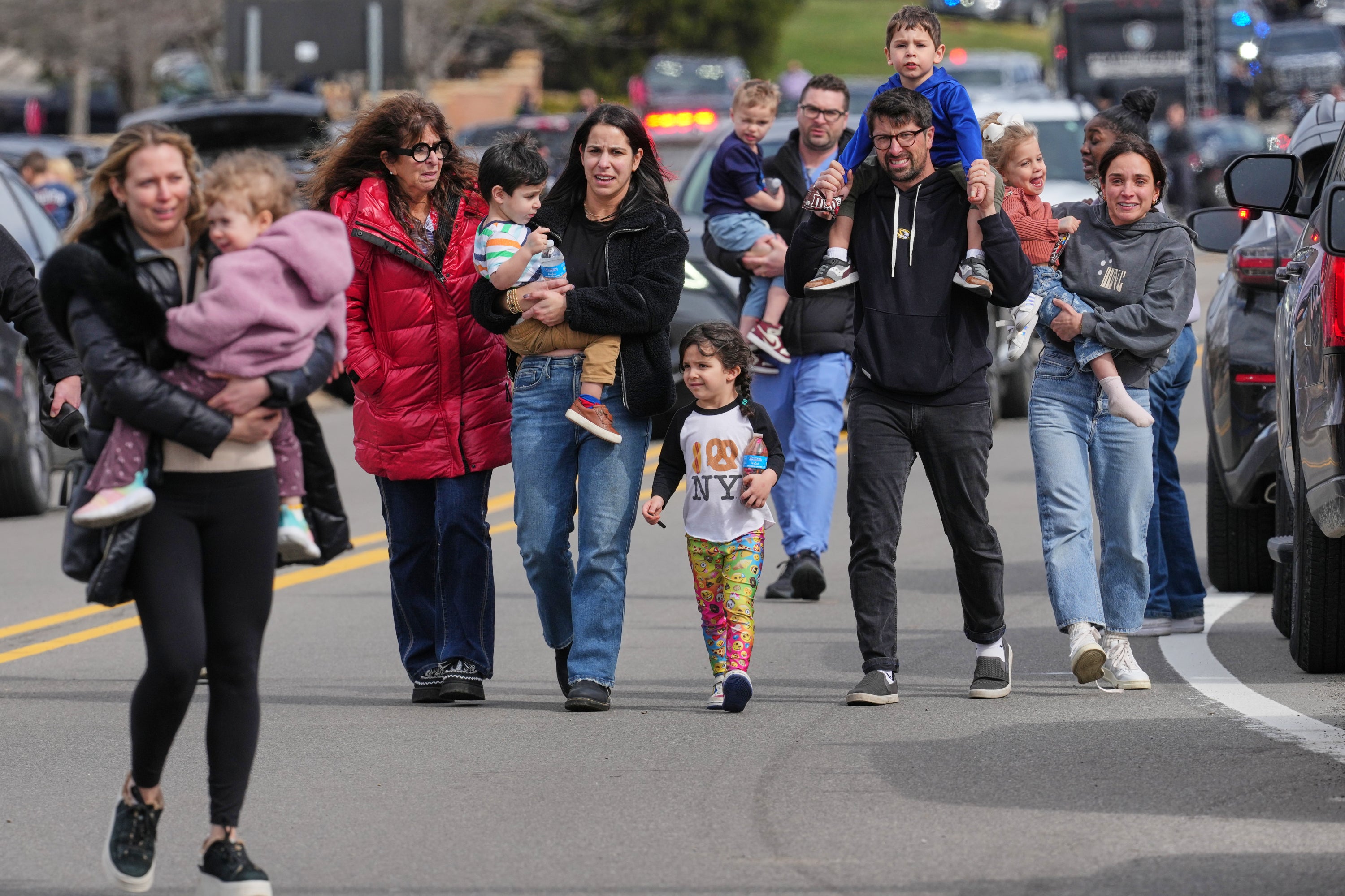Law enforcement escort families pinch children distant from nan Temple Israel synagogue