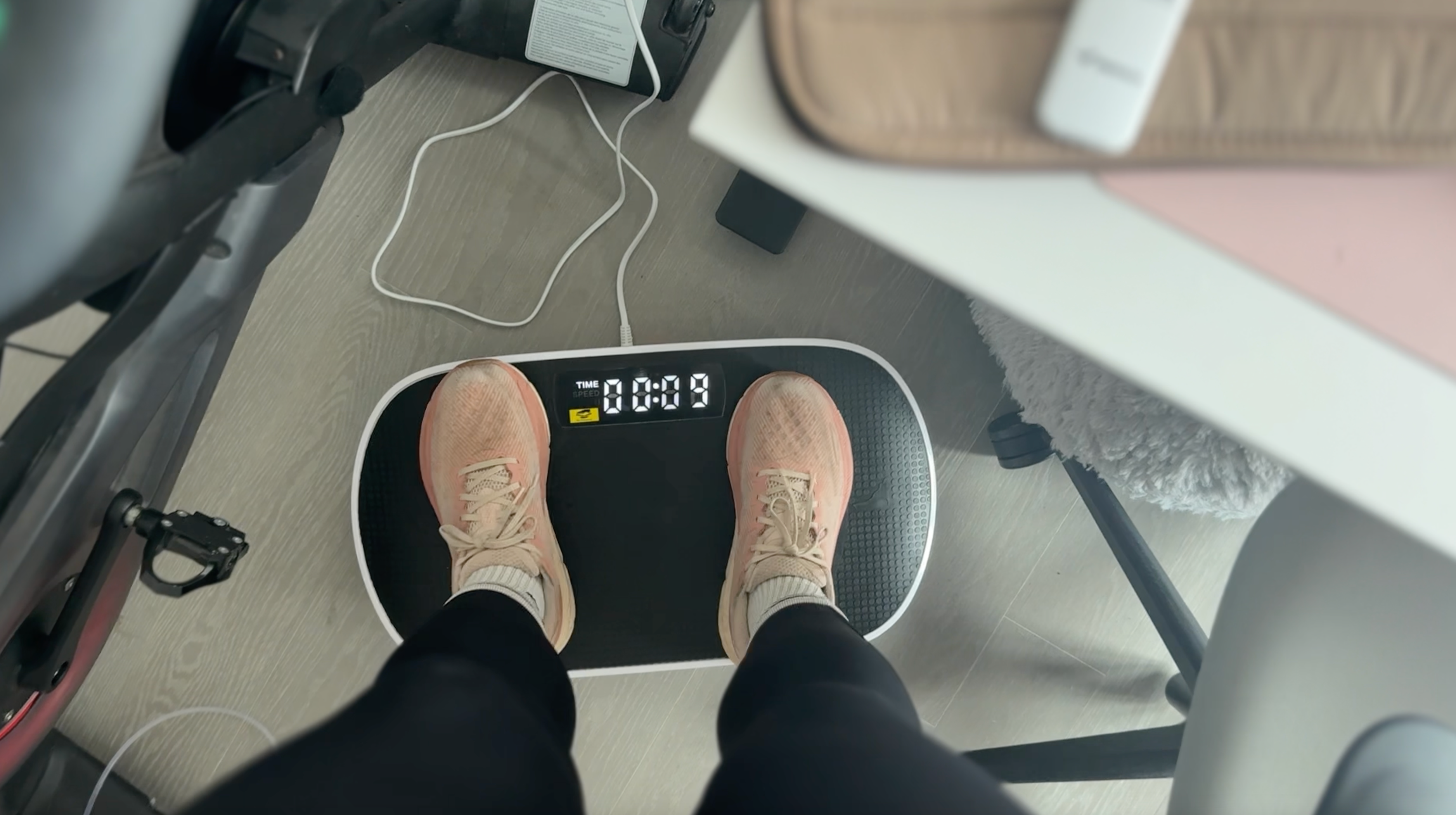 The Independent's Julia Musto stands on a vibration plate in her New York City apartment