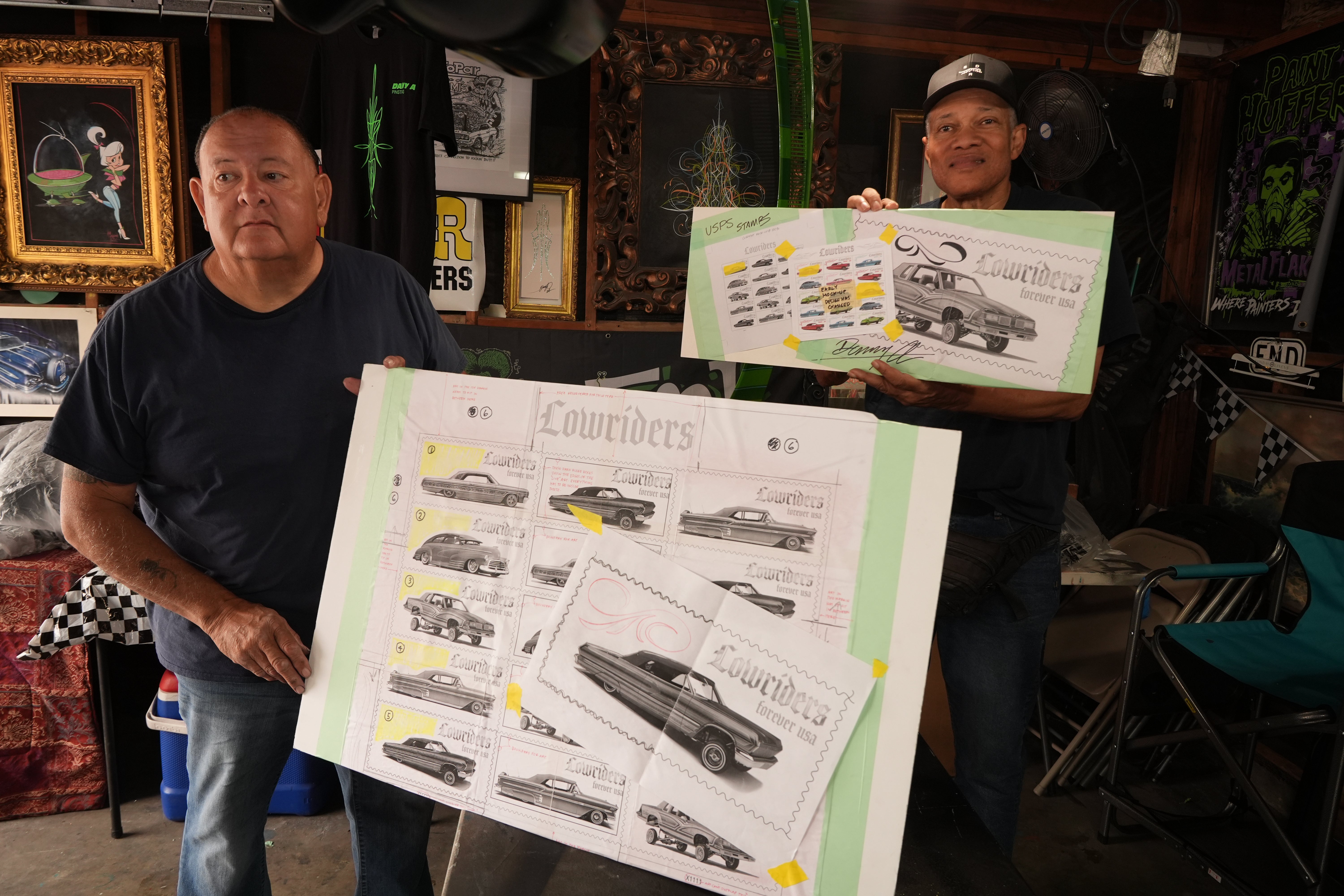 Freehand pinstriping creator Danny Alvarado, left, pinch his adjunct Clarence Spears, looks astatine sketches utilized for nan caller United States Postal Service lowriders stamps astatine his shop successful Monrovia, Calif.