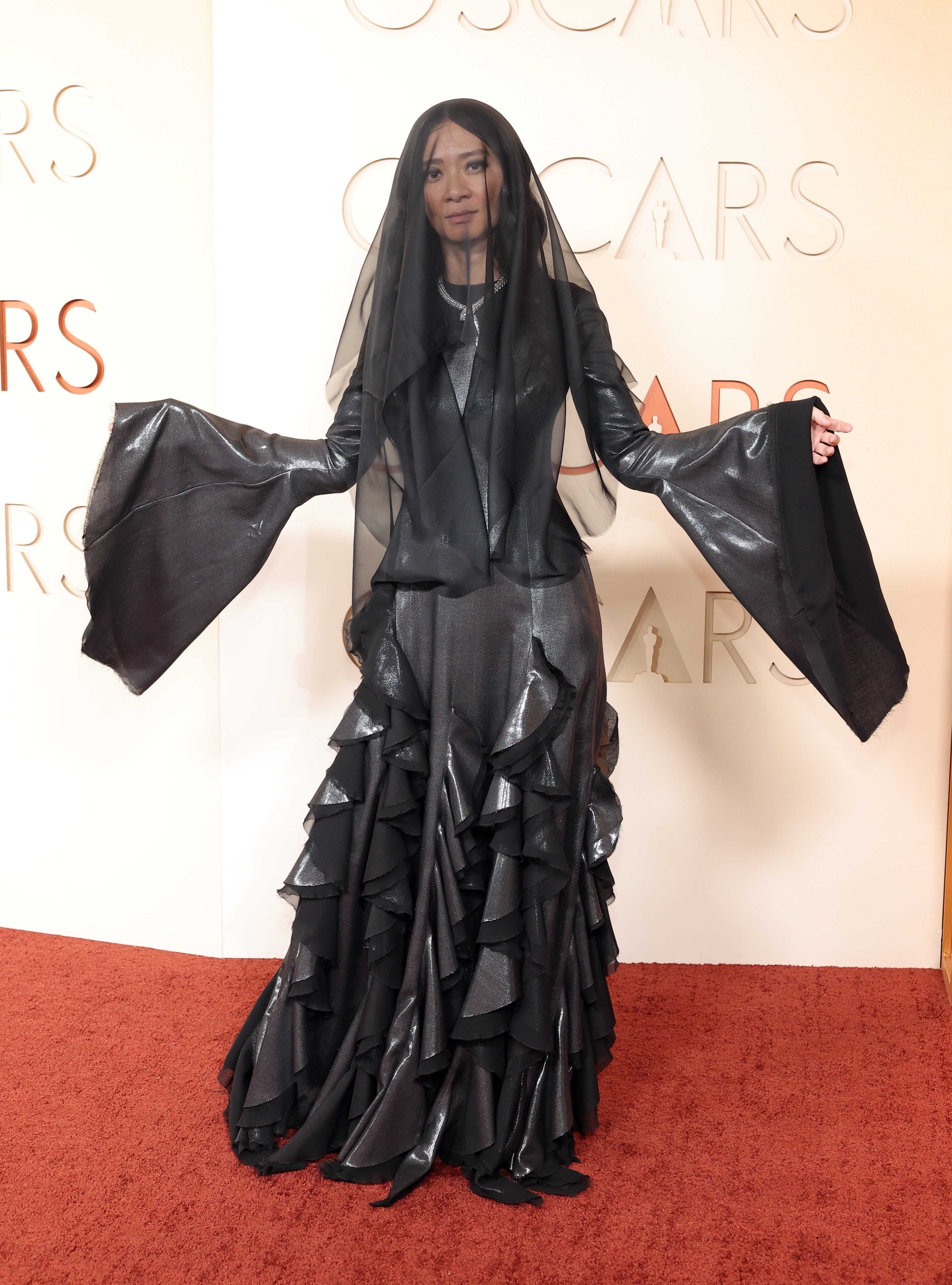 The ‘Hamnet’ director looked more at home in the Addams Family, wearing a black Gabriela Hearst gown with draped sleeves and an eerie black veil