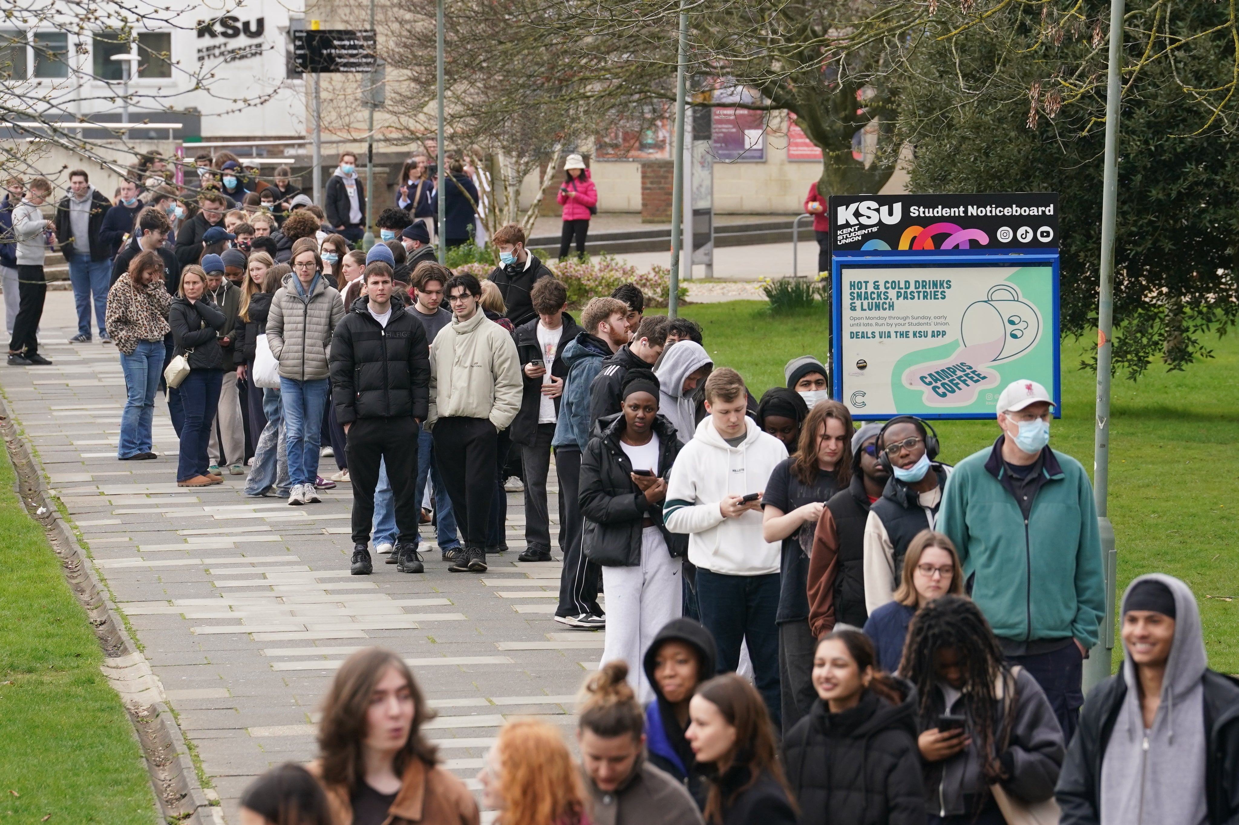 Students queueing outside a building at the University of Kent in Canterbury on Monday