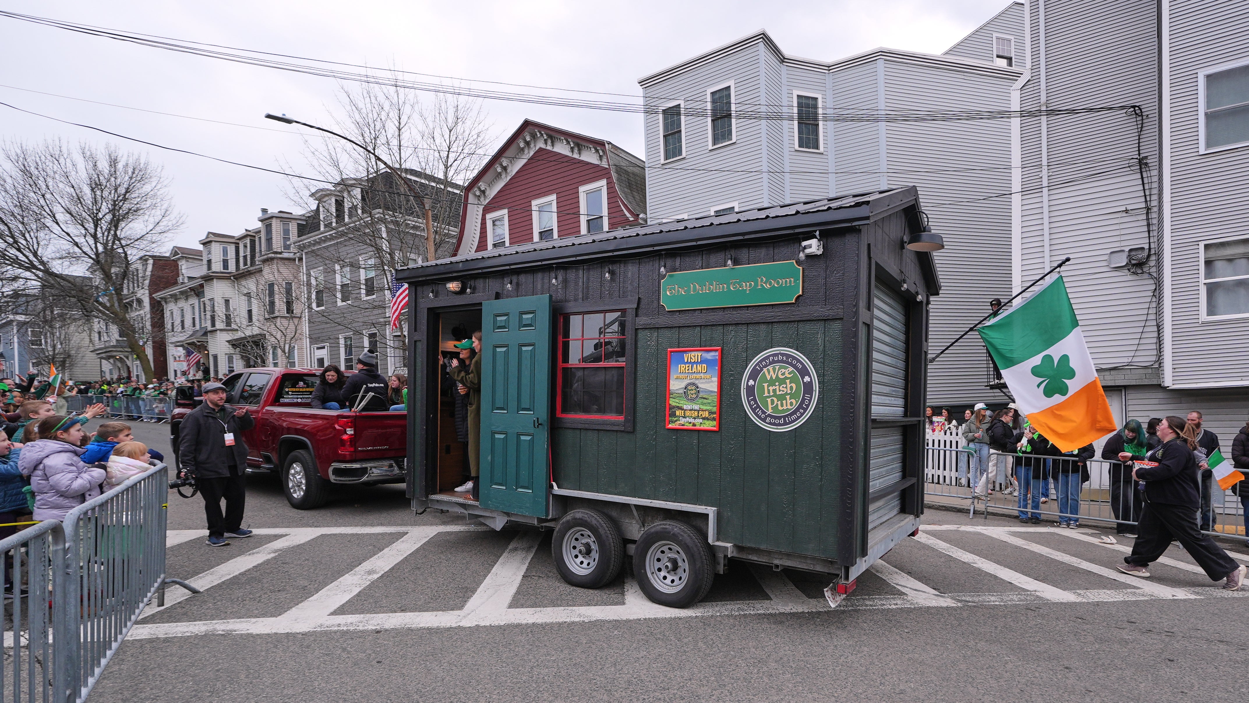 The "Wee Irish Pub", a afloat functioning mobile Irish pub built by 2 Massachusetts' brothers, is towed during nan yearly St. Patrick's Day parade done nan South Boston neighborhood, Sunday, March 15, 2026. (AP Photo/Charles Krupa)
