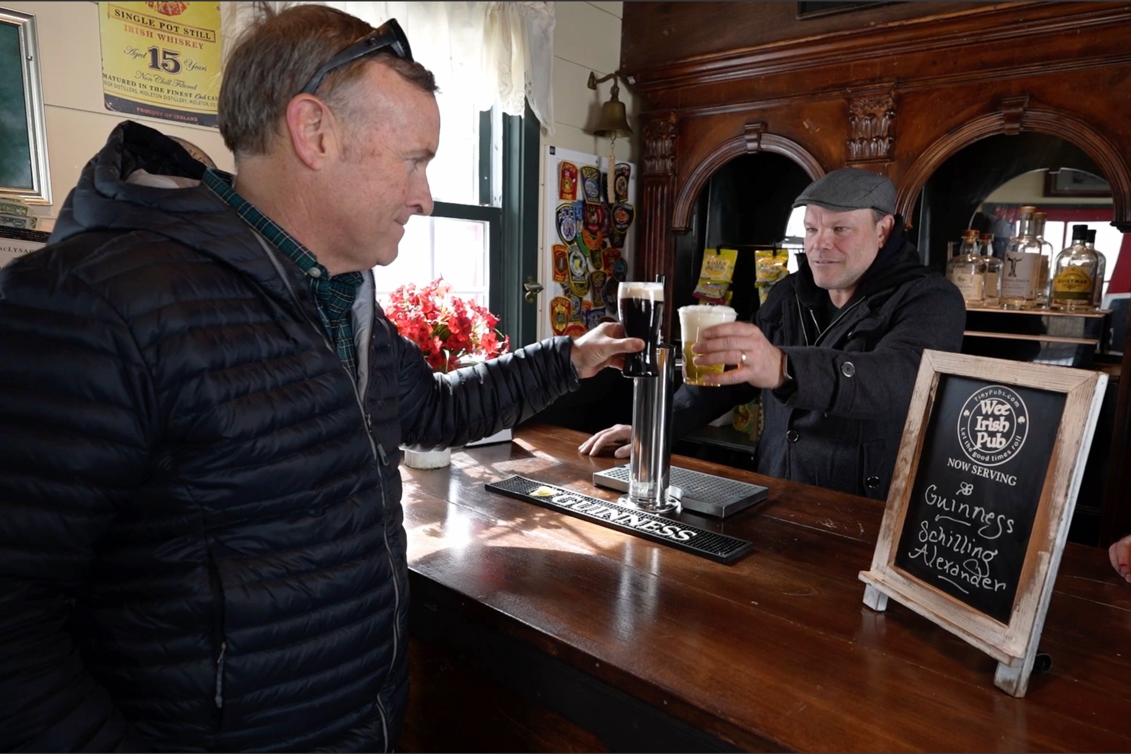 Mark Cote, left, toasts Matt Taylor aft receiving transportation of a rented mini pub for an early St. Patrick's Day party, Friday, March 13, 2026, successful Andover, Mass. (AP Photo/Robert F. Bukaty)