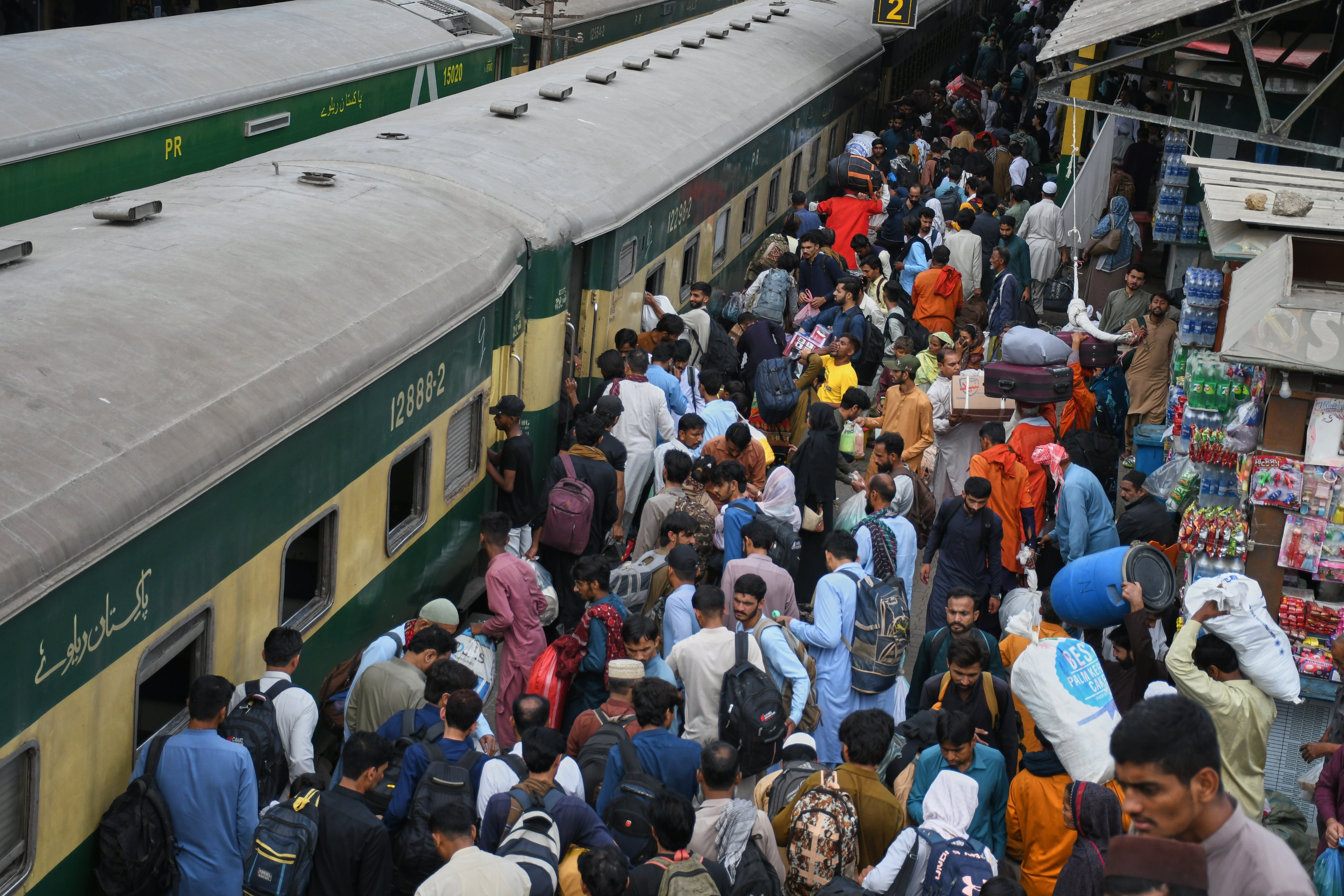 People wait for passenger trains to return home to celebrate the upcoming Eid al-Fitr holidays