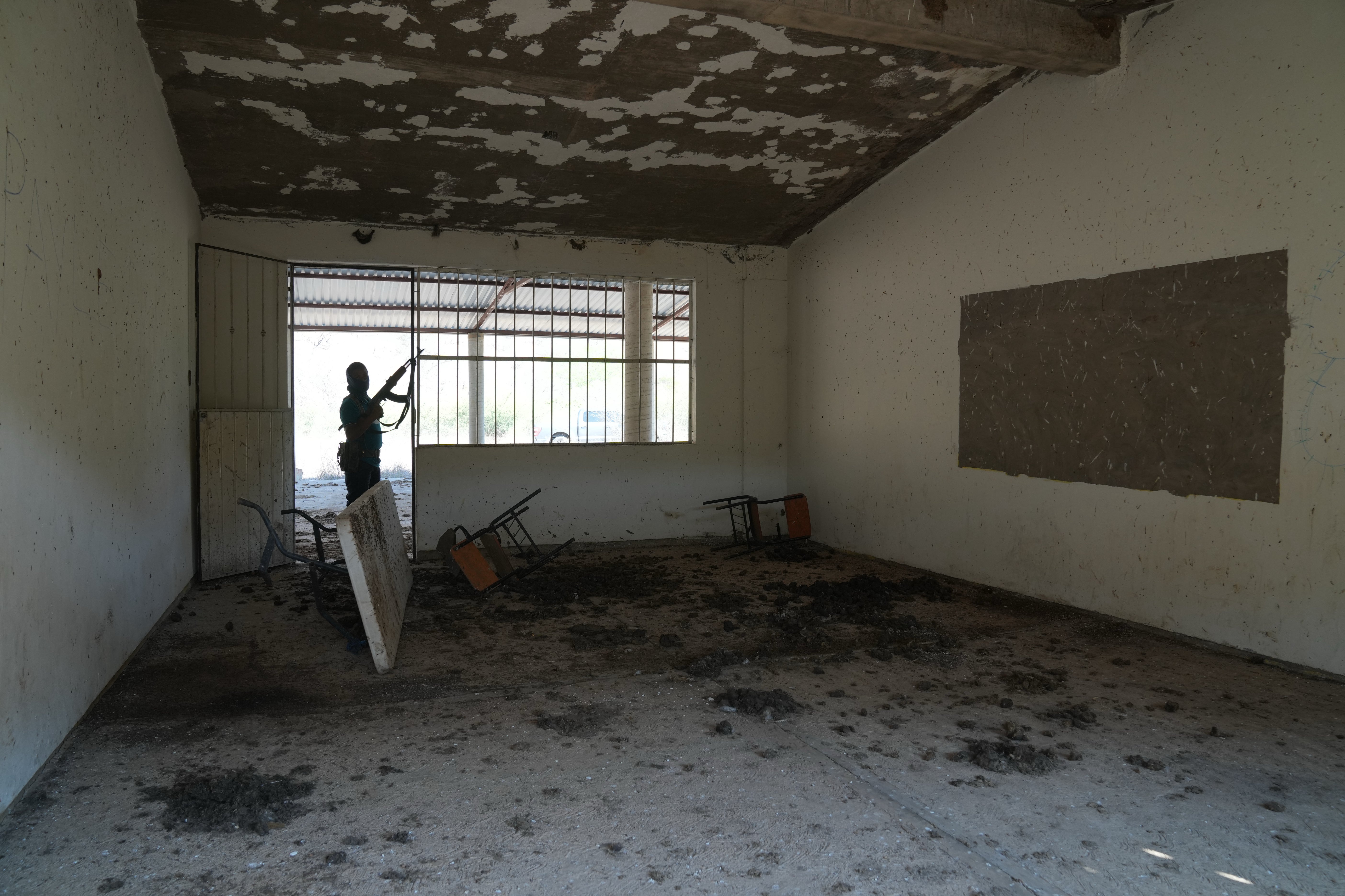 A personnel of a section self-defense group formed by residents successful consequence to cartel unit guards a closed schoolhouse successful Guajes de Ayala, Mexico, Wednesday, March 11, 2026. (AP Photo/Marco Ugarte)