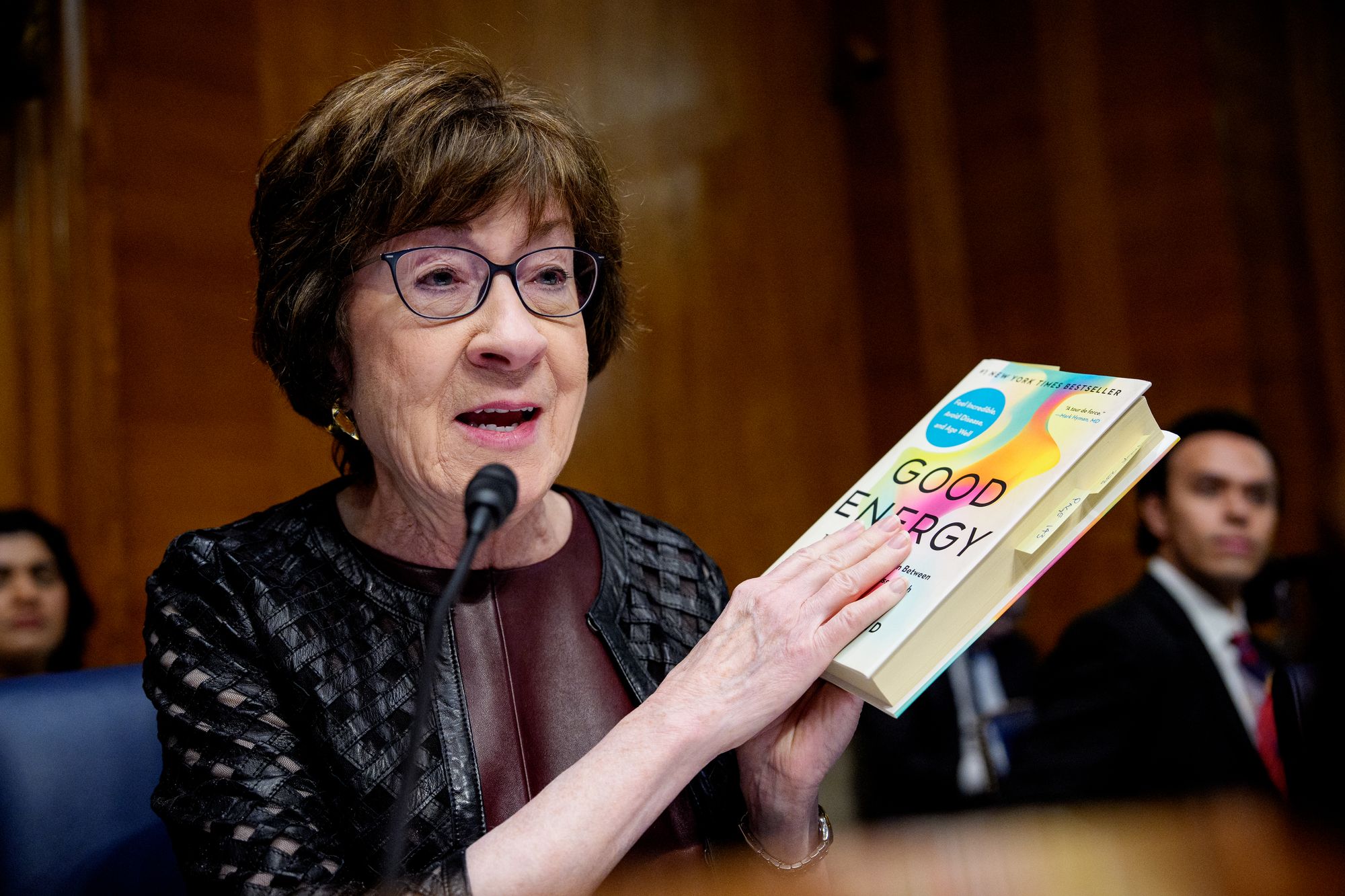 Sen. Susan Collins holds up Dr. Casey Means' book 'Good Energy' during her information hearing
