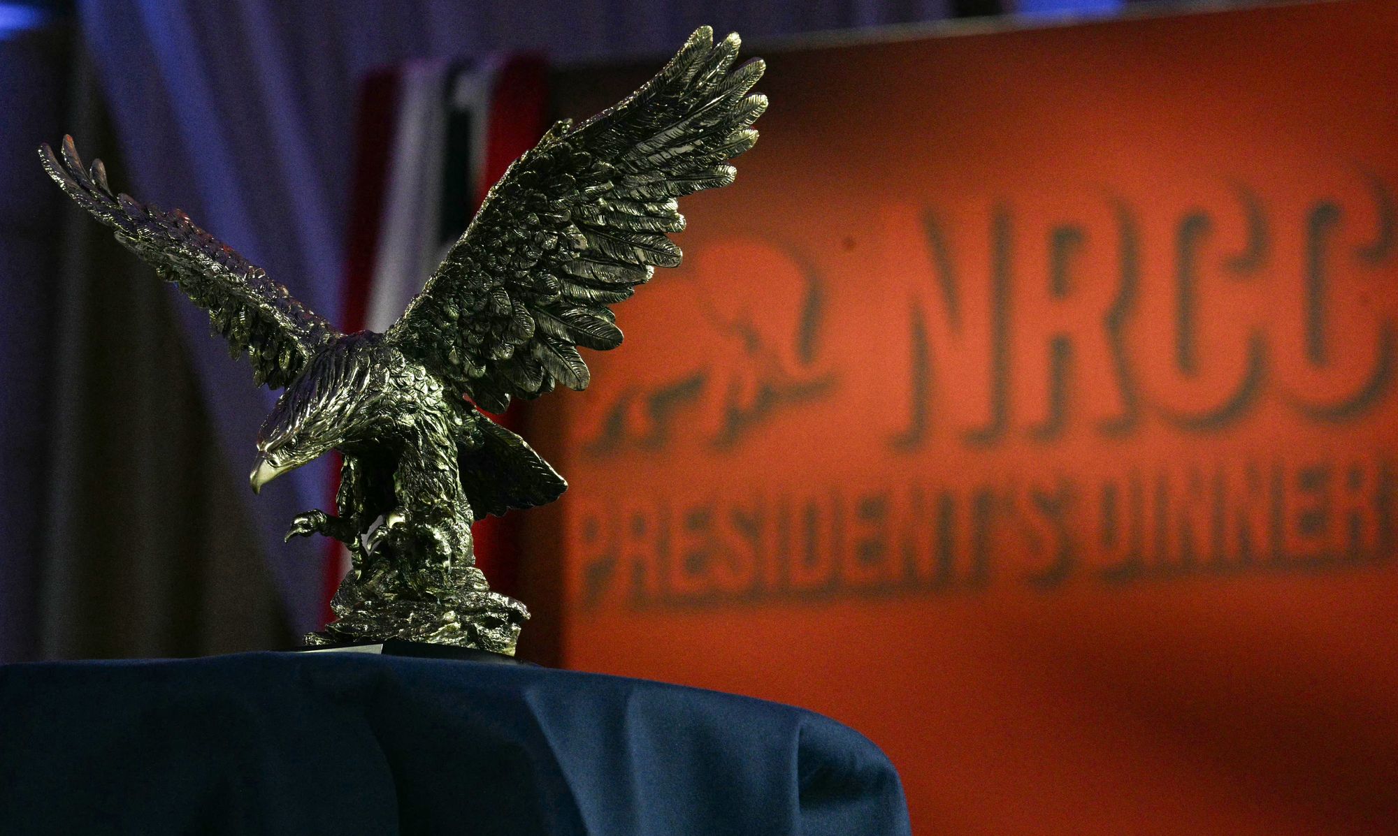 The America First Award, represented by an eagle statue, is displayed connected nan broadside of nan shape up of its position to Trump astatine nan Republican fundraiser