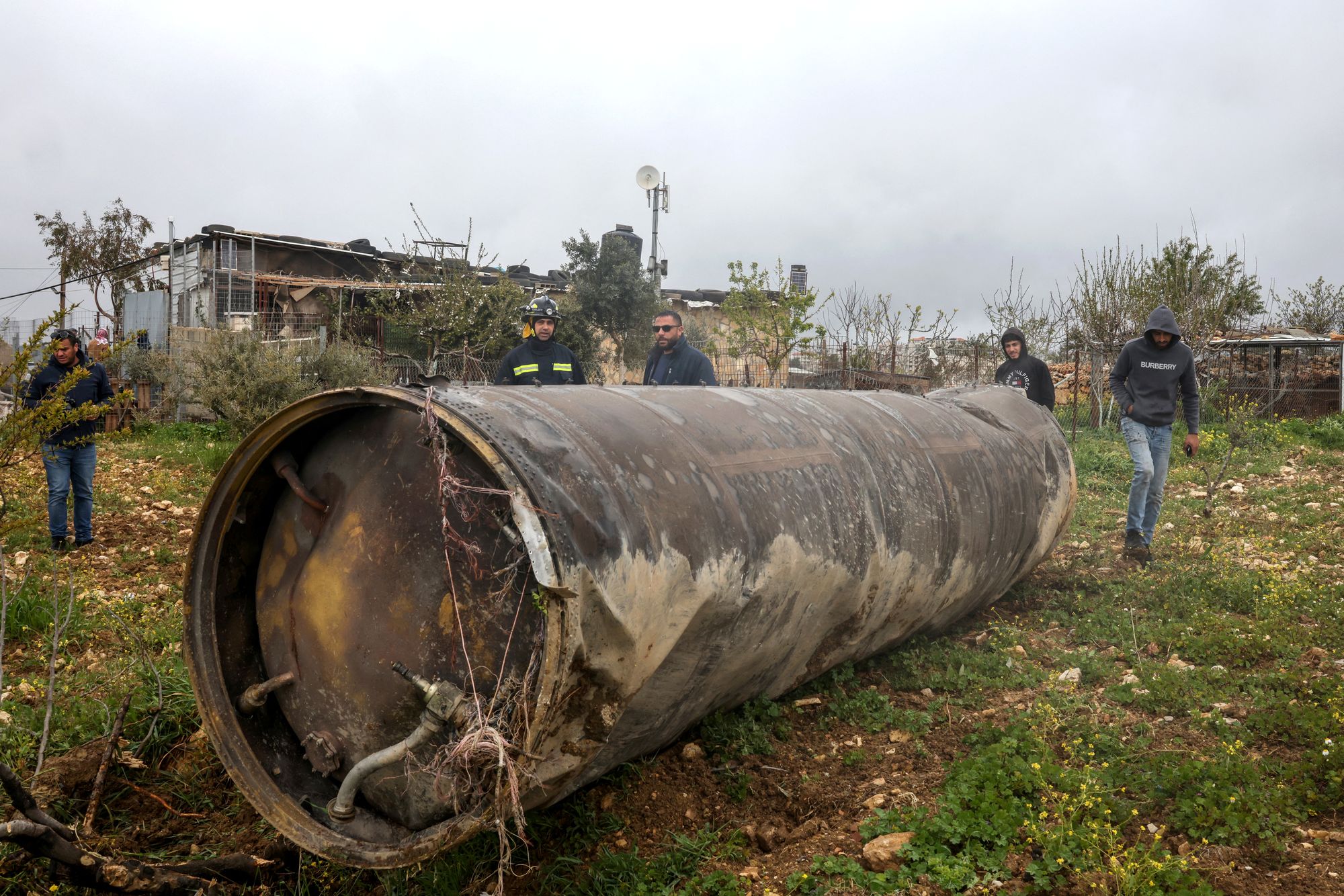 Palestinian residents inspect nan remnants of an rocket that landed successful nan Israeli-occupied West Bank colony of Beitin, northeast of nan metropolis of Ramallah