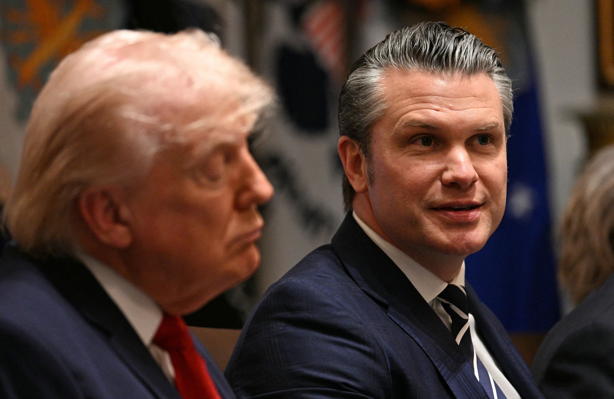 US Defense Secretary Pete Hegseth speaks arsenic President Donald Trump looks connected during a furniture gathering successful nan Cabinet Room of nan White House successful Washington, DC, connected March 26, 2026