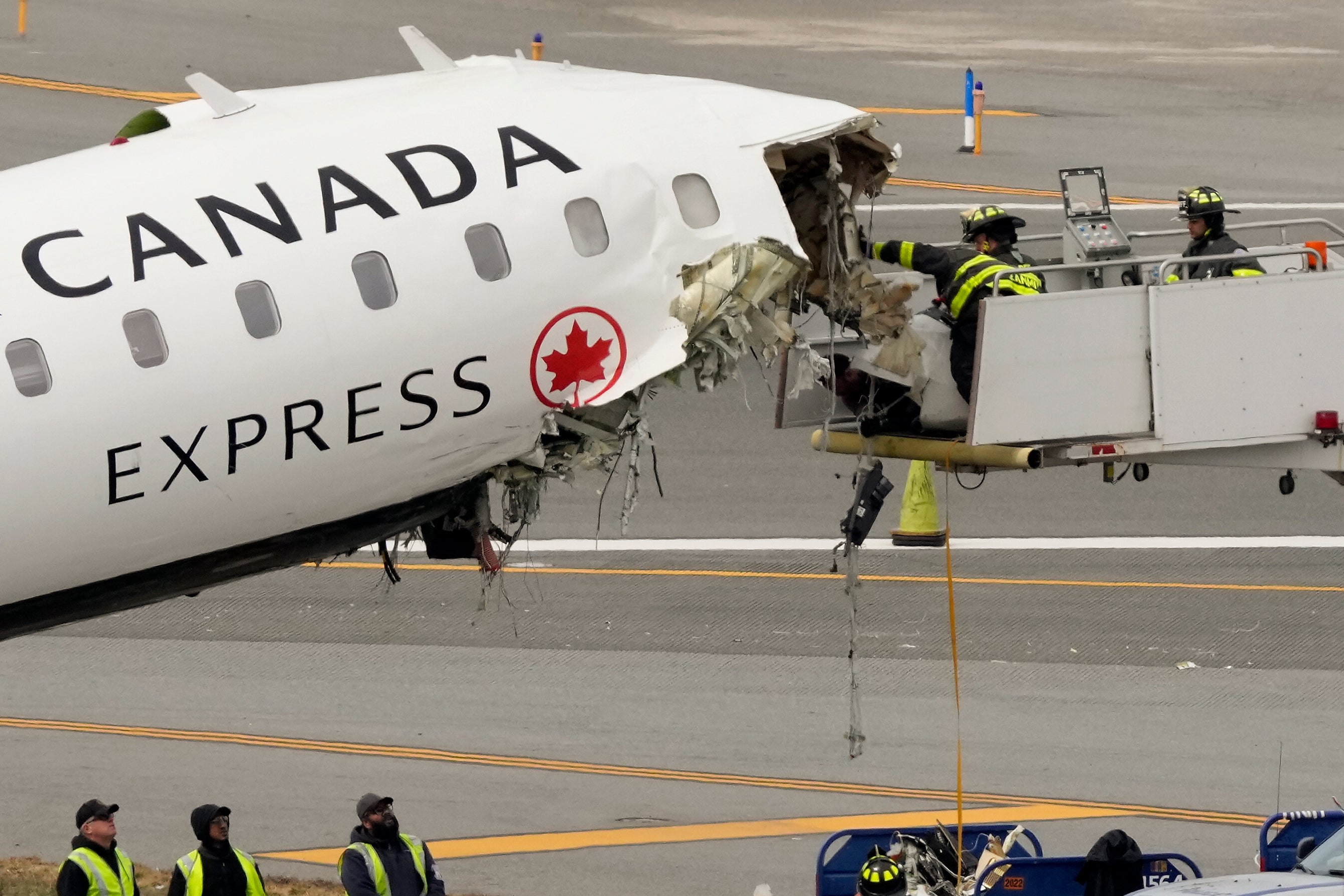 Airport firefighters region loose debris from nan wreckage of an Air Canada Express jet, Wednesday, March 25, 2026, conscionable disconnected nan runway wherever it had collided pinch a Port Authority occurrence motortruck Sunday nighttime astatine LaGuardia Airport successful New York
