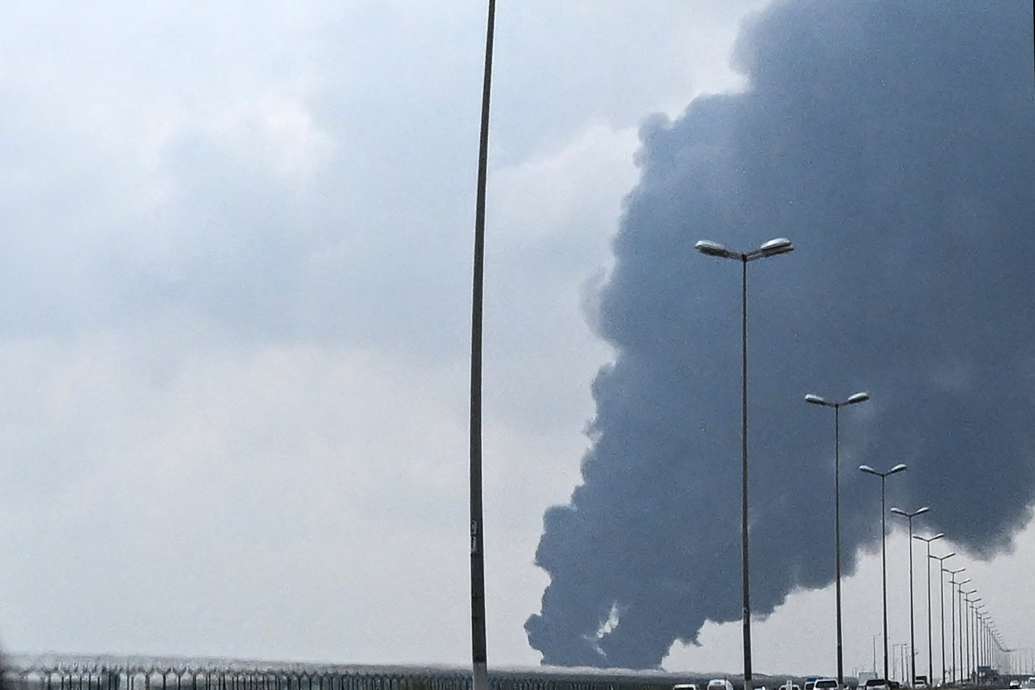 Smoke rises from nan area of nan Kuwait International Airport aft a reported drone onslaught deed a substance depot connected March 25, 2026