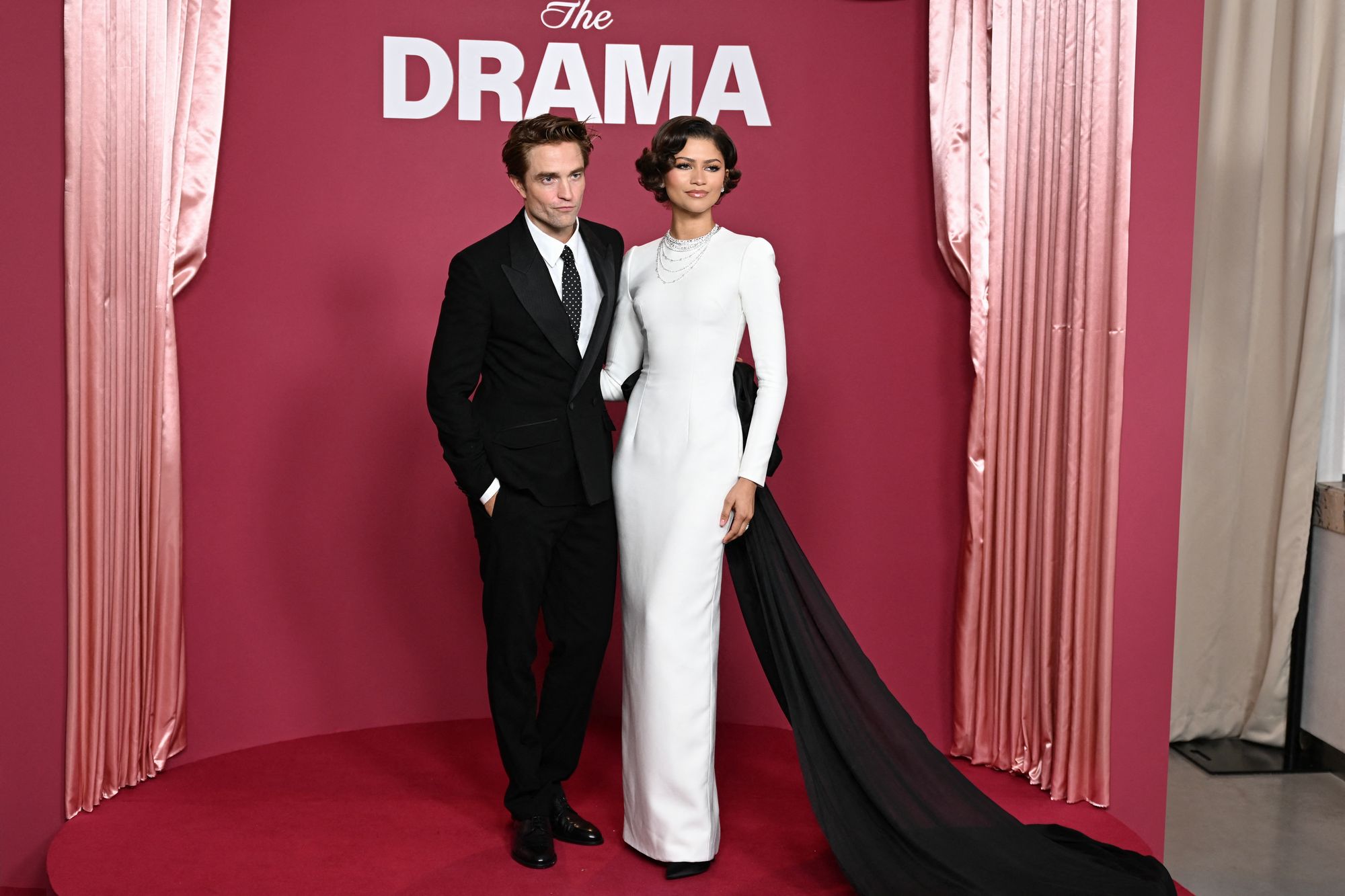 “Something new” came at the March 24 Paris premiere, a white custom Louis Vuitton gown with a huge black bow and train