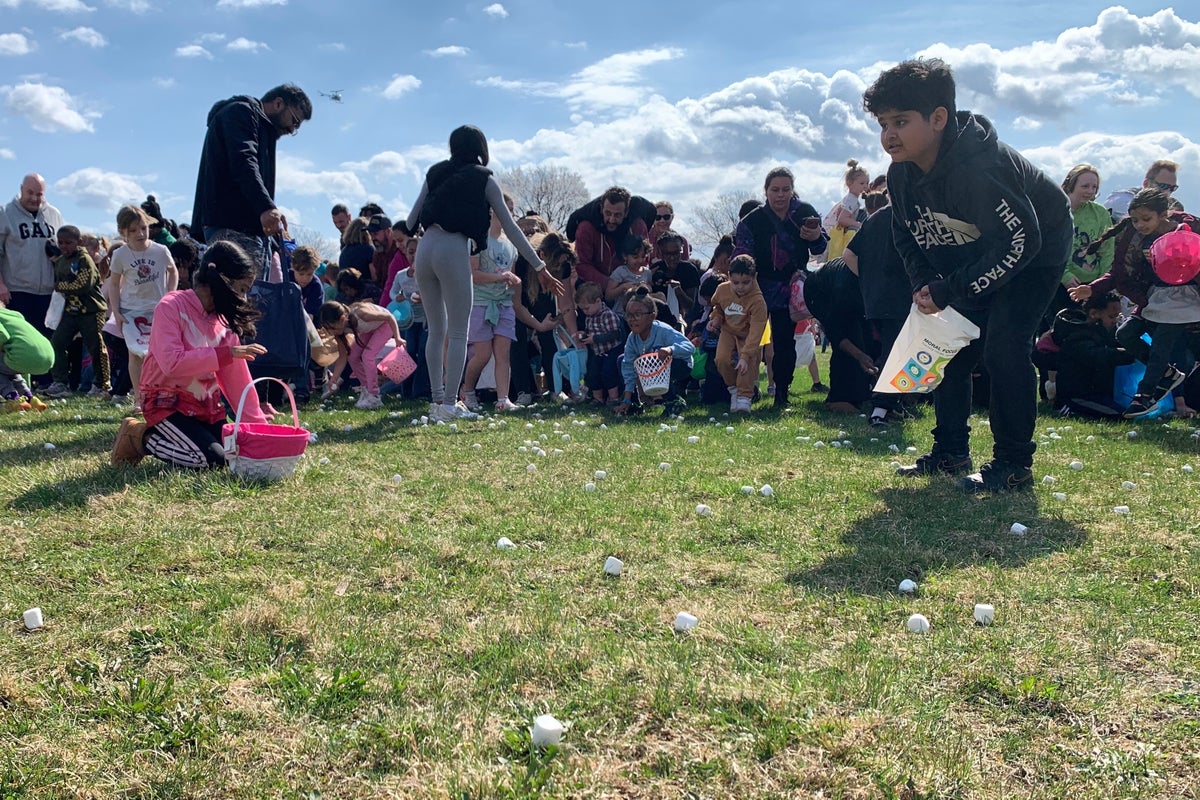 Thousands of marshmallows fall from helicopter as children scramble at Easter event