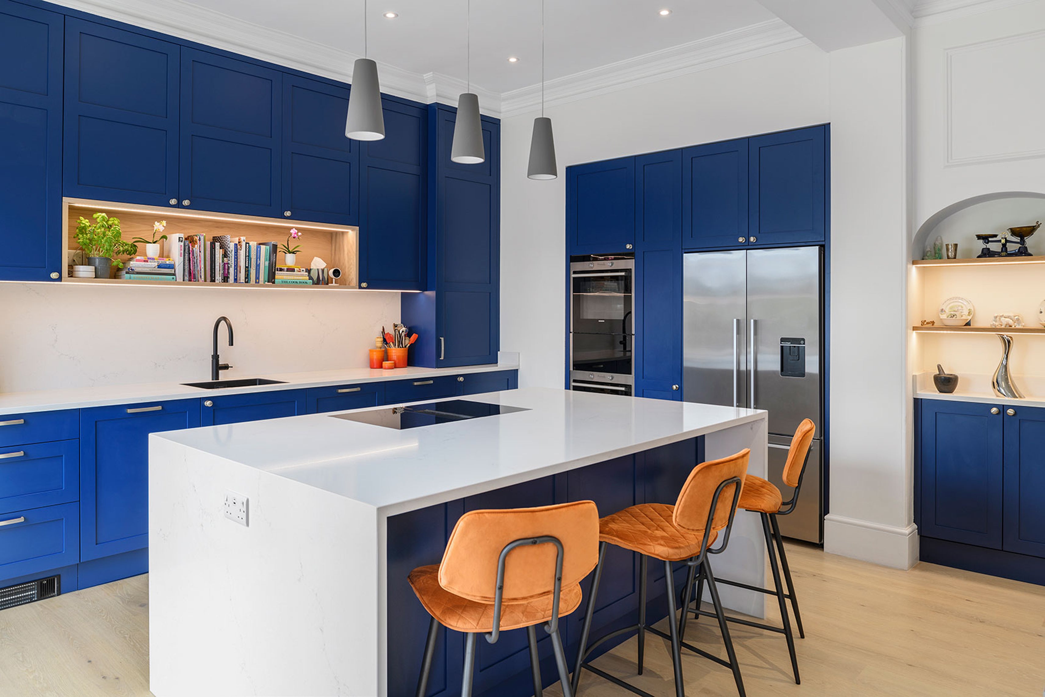Thoughtfully considered and layered lighting choices in a fun contemporary kitchen (Deborah Law Interiors/Jonathan Little Photography/PA)