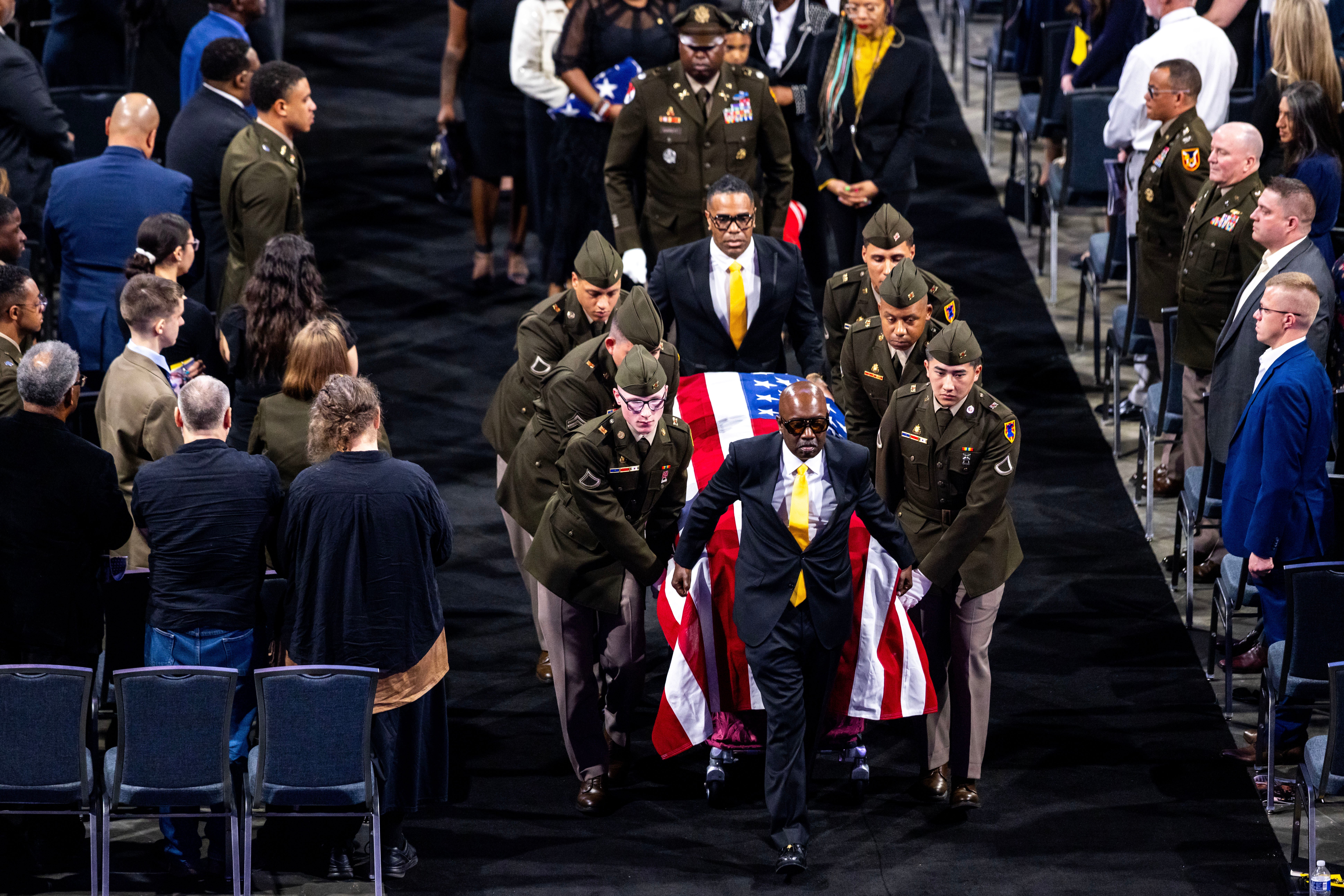The body of Lt. Col. Brandon Shah is carried out of his funeral service at Old Dominion University in Norfolk, Va., March 22, 2026