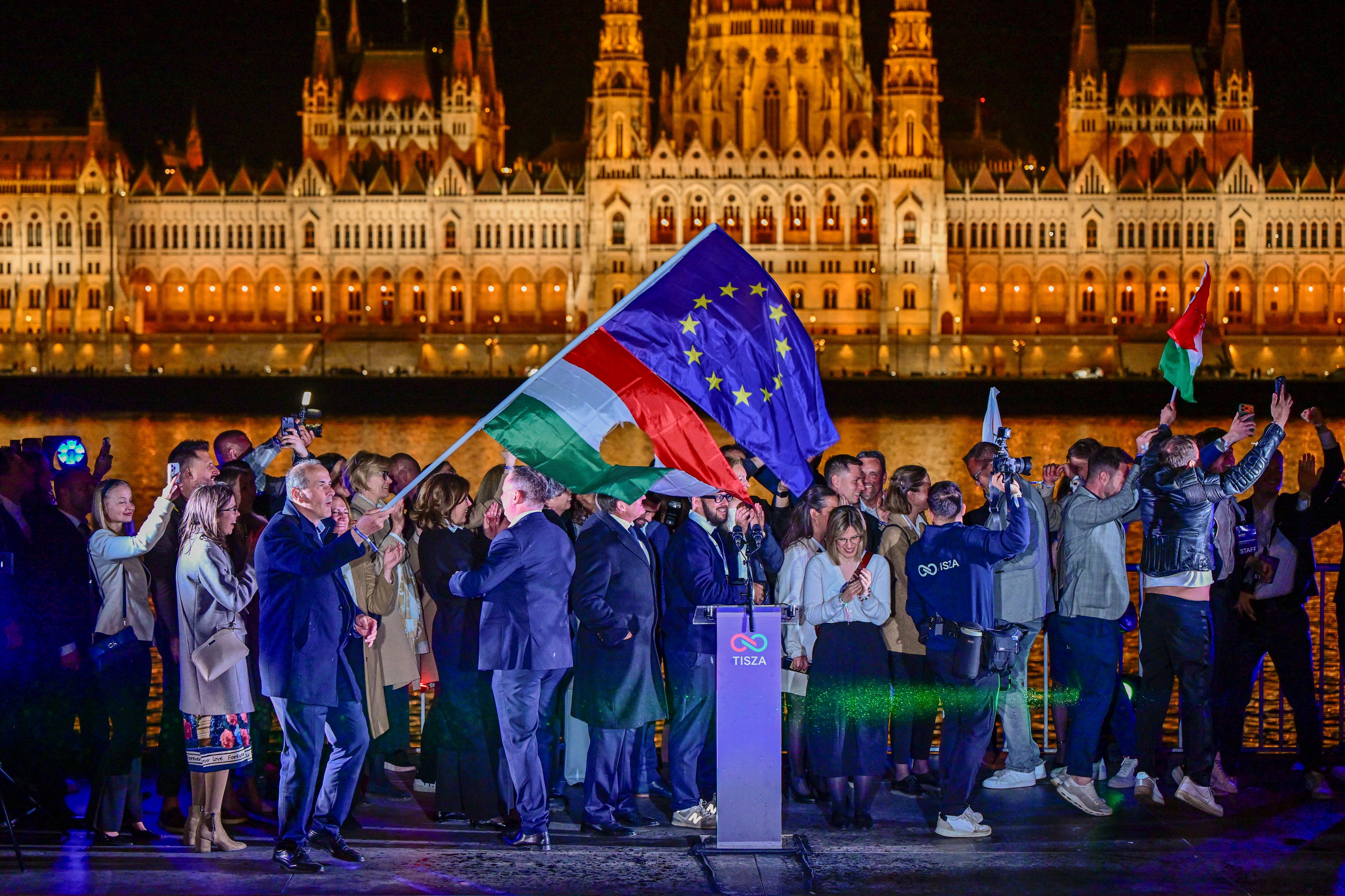 The European Union and revolutionary national flags fly after a speech by Peter Magyar