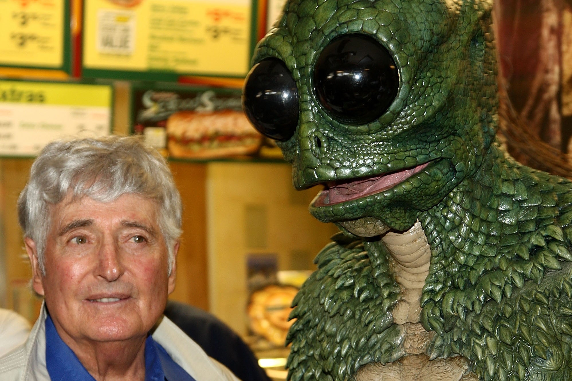 Children's television producer Sid Krofft, pictured with a Sleestak from ‘Land of the Lost,’ has died at 96