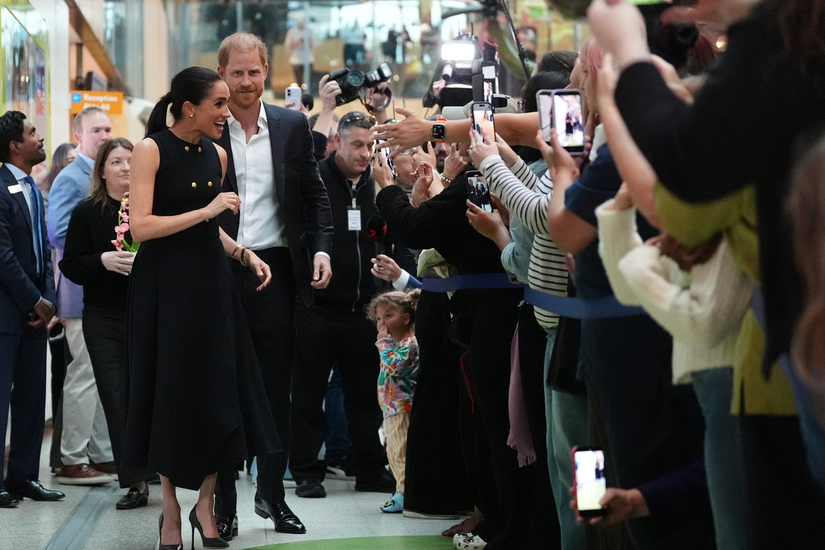 Prince Harry and Meghan arrive in Australia for a low-key, privately funded visit