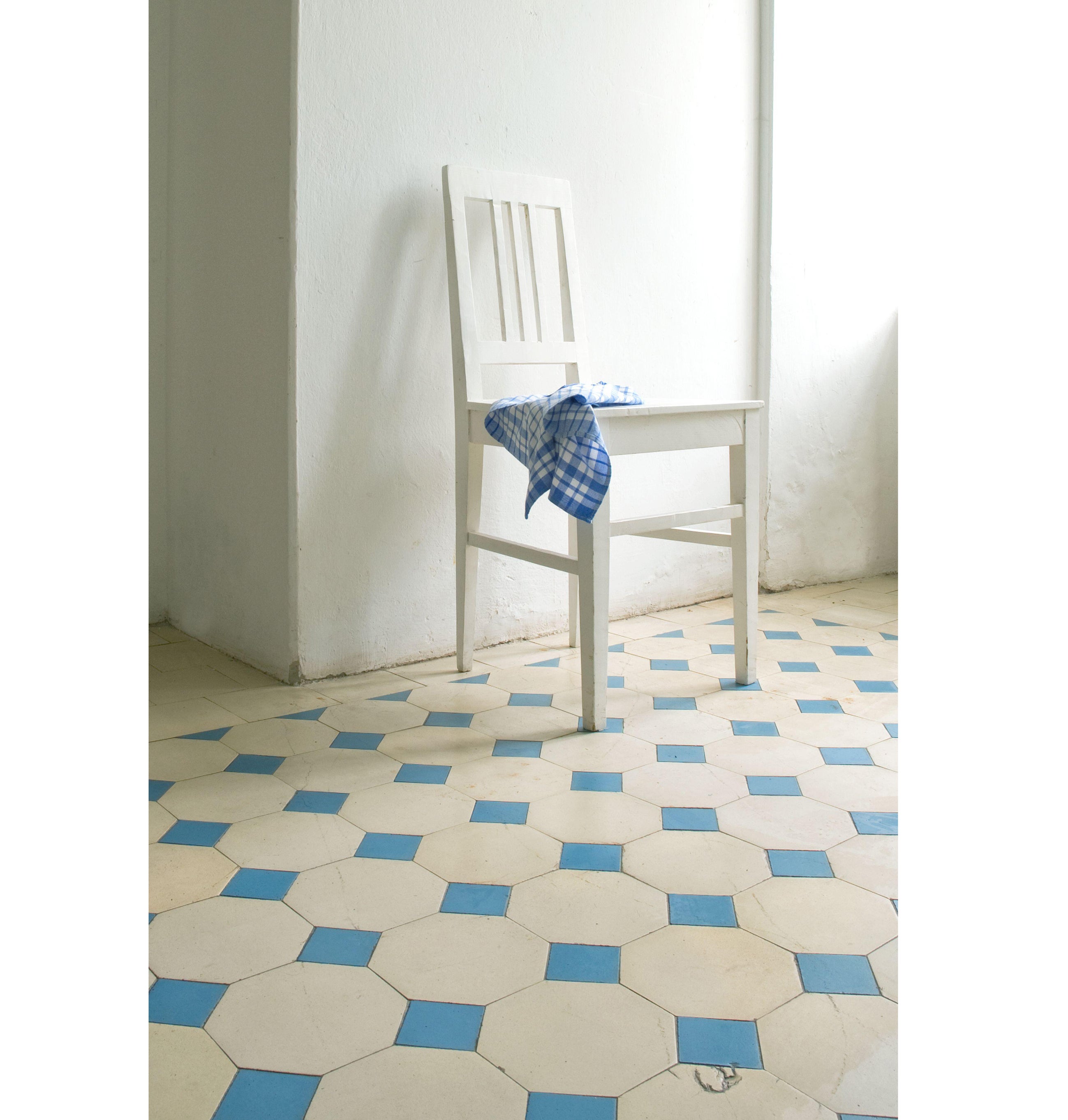 White kitchen chair with blue tiled kitchen floor