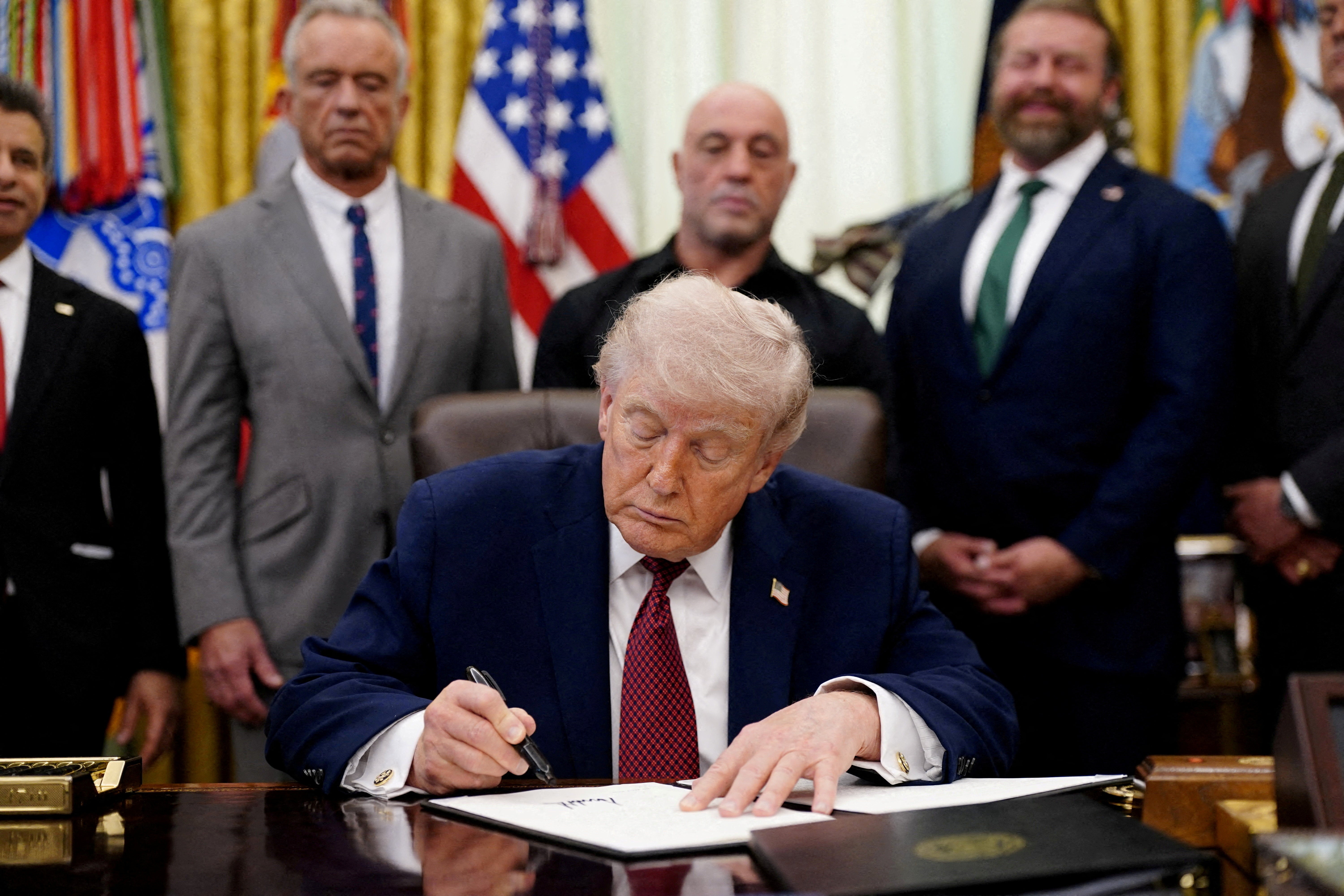 Trump signs an executive bid encouraging much investigation into ibogaine, adjacent to U.S. Health and Human Services (HHS) Secretary Robert F. Kennedy Jr., Joe Rogan, and Americans for Ibogaine CEO W. Bryan Hubbard, successful nan Oval Office