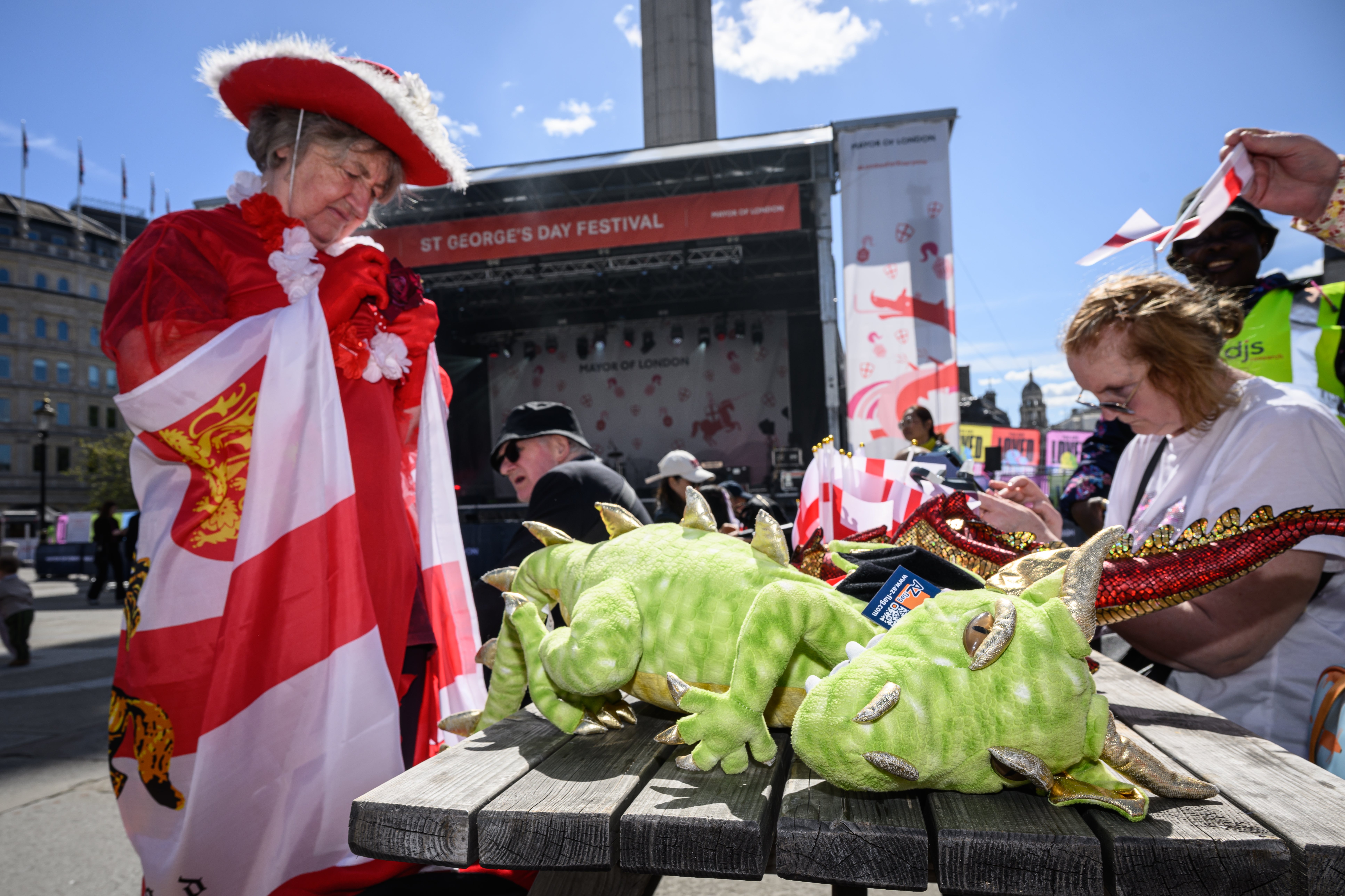 A woman assembles her St George and dragon costume during the St George's Day celebrations in Trafalgar Square
