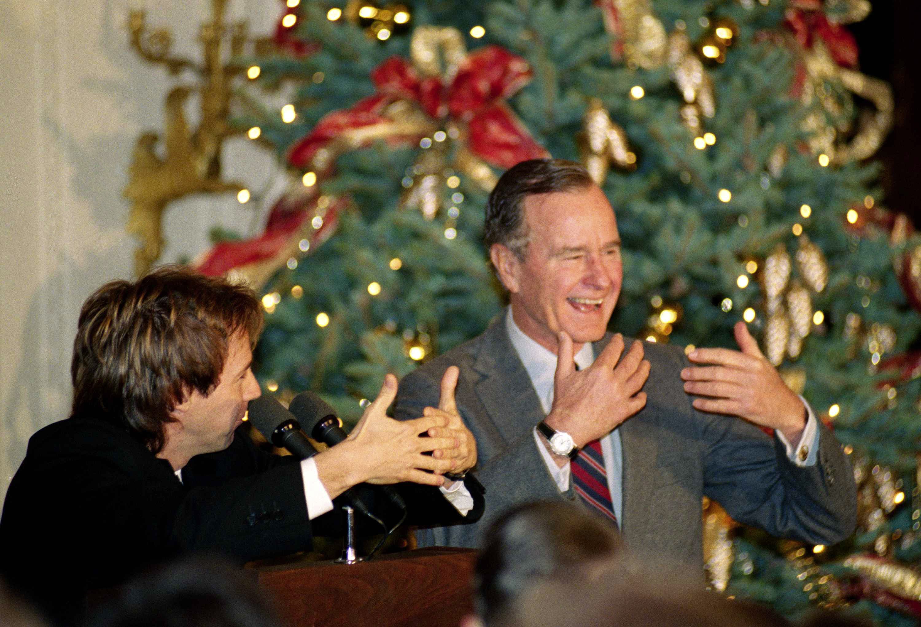 Comic Dana Carvey, left, shows President George H.W. Bush really to imitate himself