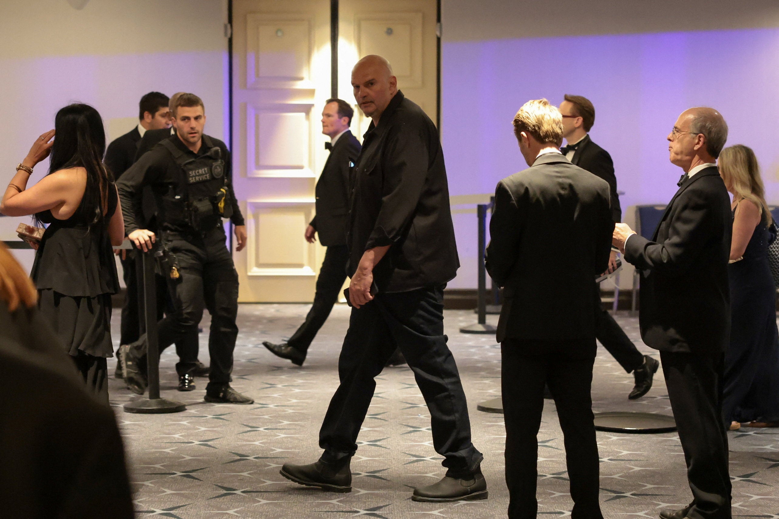 Sen. John Fetterman (D-PA) is escorted done nan lobby pursuing nan shooting astatine nan yearly White House Correspondents’ Association meal Saturday night