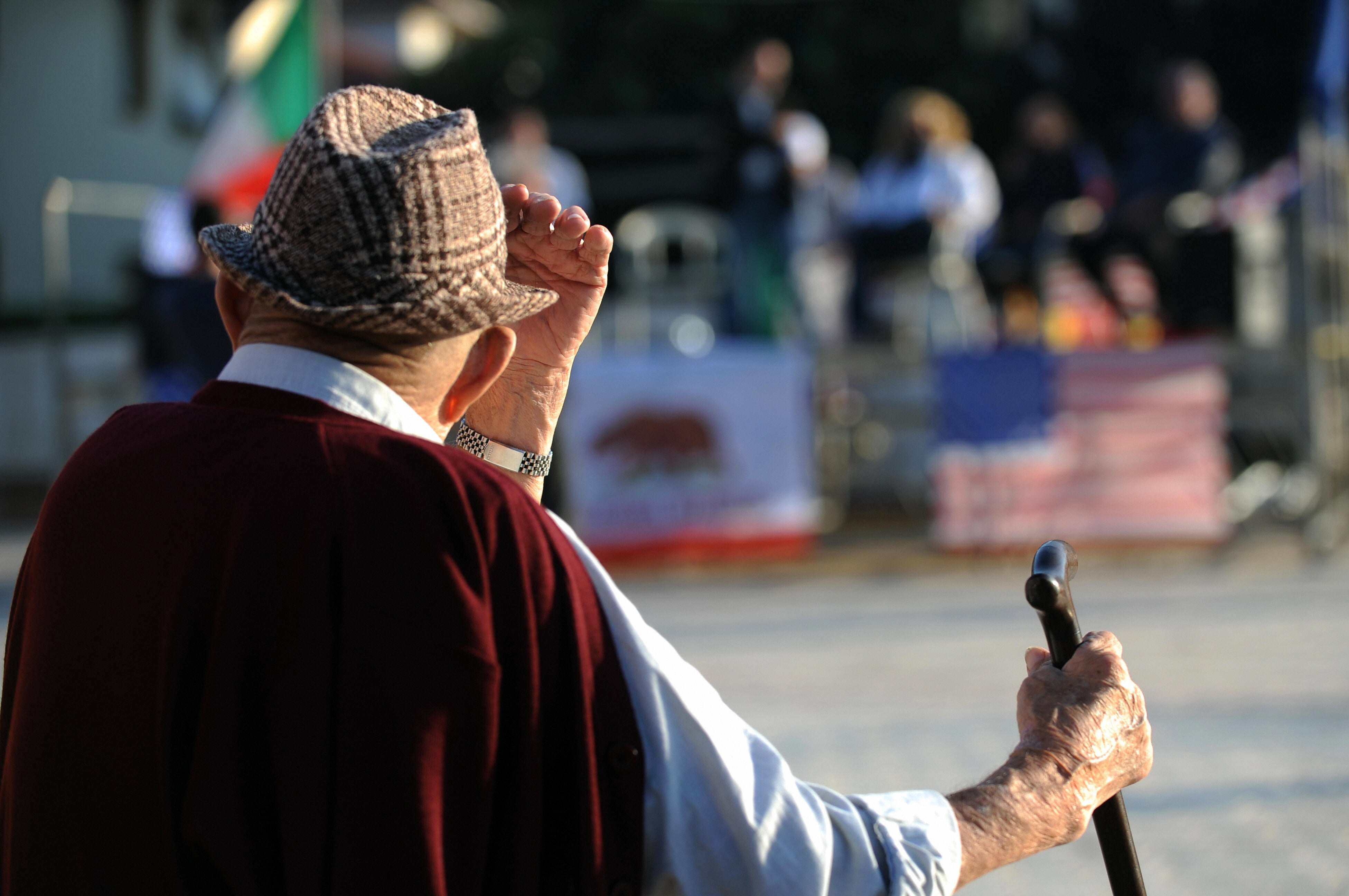An elderly villager looks at a candidate's rally in Tuscany, Italy
