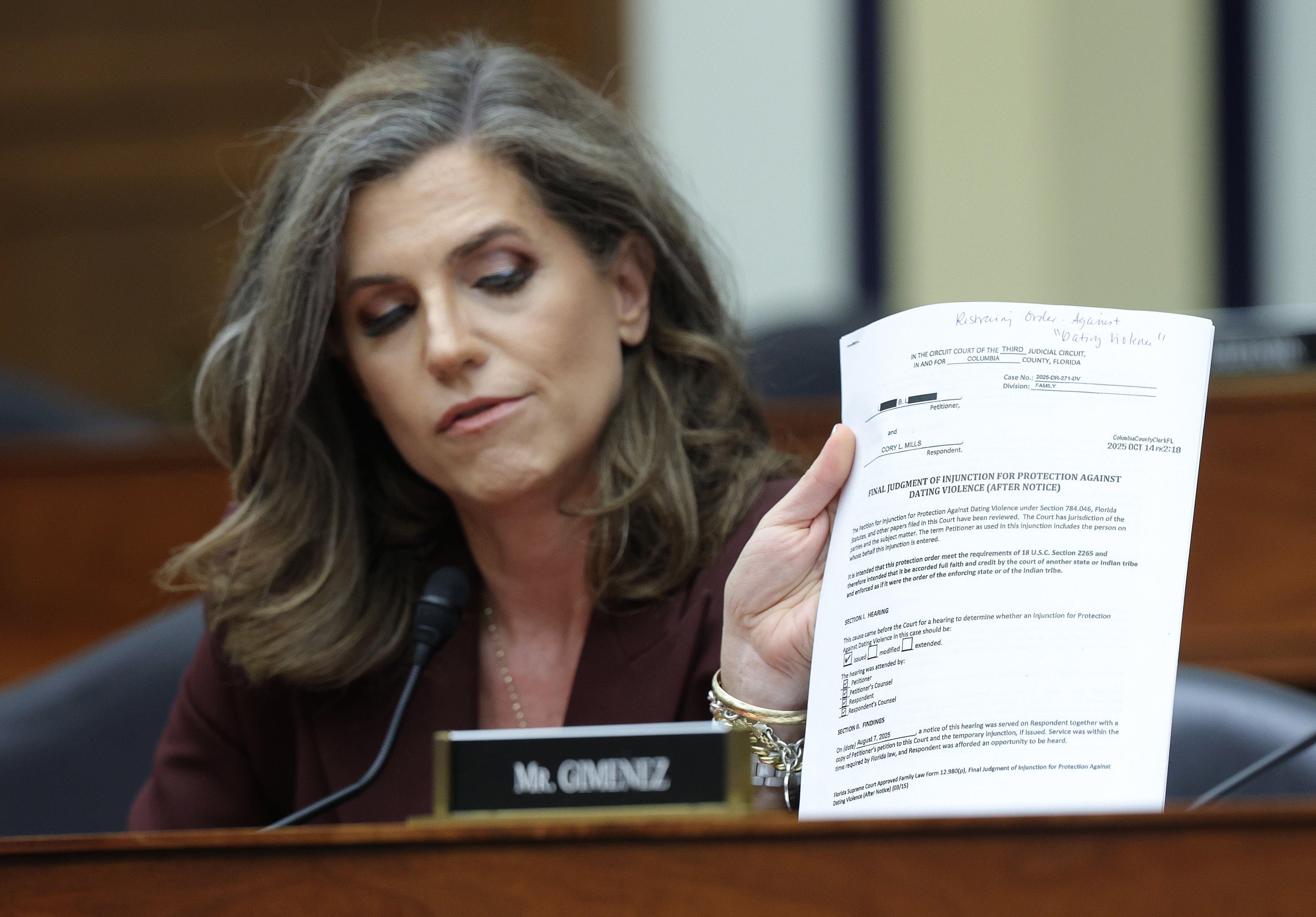Rep. Nancy Mace (R-SC) presents documents related to Rep. Cory Mills (R-FL) arsenic she participates successful nan House Armed Services Committee proceeding pinch Hegseth