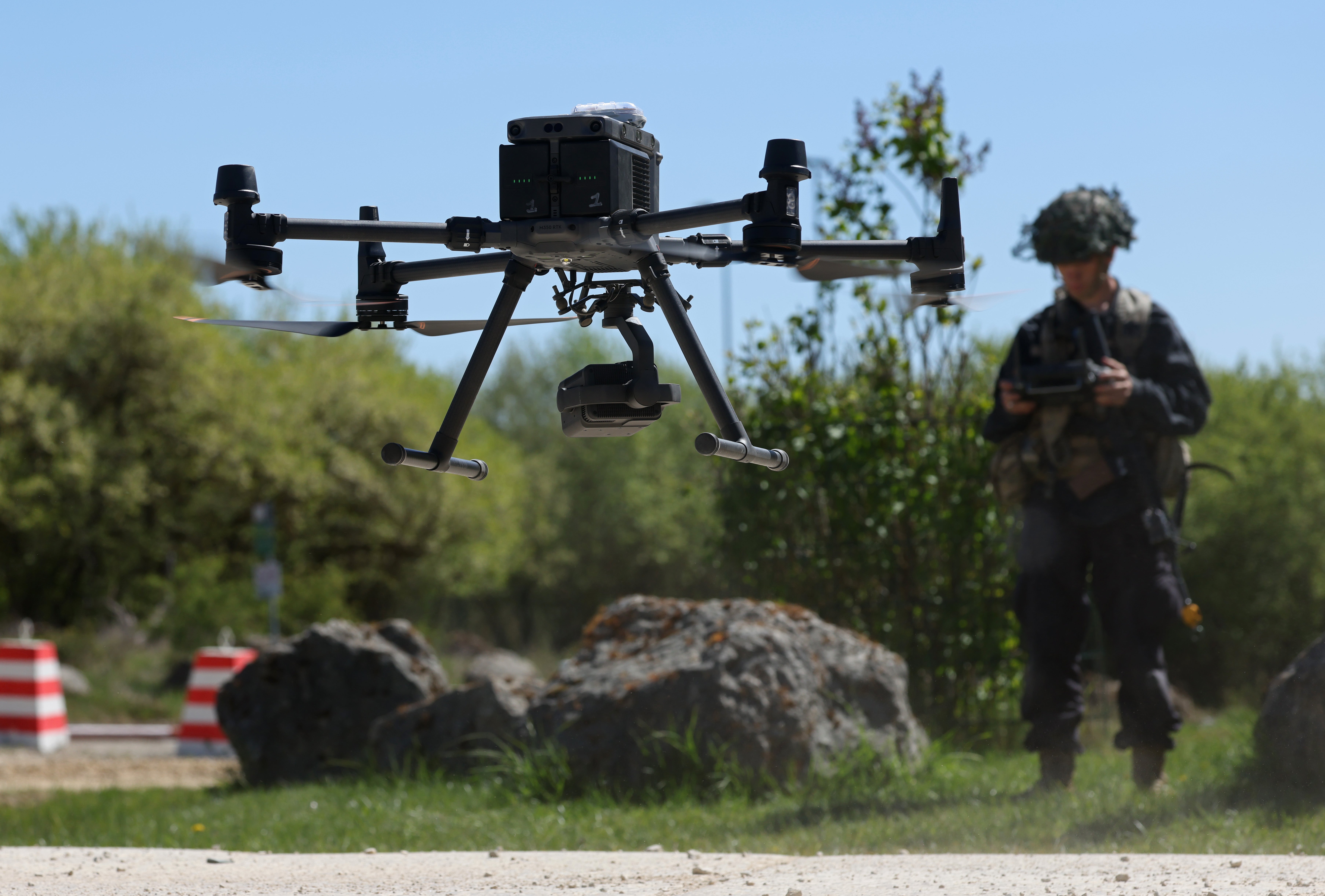 A personnel of nan U.S. Army 7th Army Training Command, clad successful achromatic successful nan domiciled of guidance force, pilots a DJI Matrice drone during nan ‘Combined Resolve’ subject workout astatine nan 7th ATC Joint Multinational Readiness Center connected April 30, 2026 successful Hohenfels, Germany