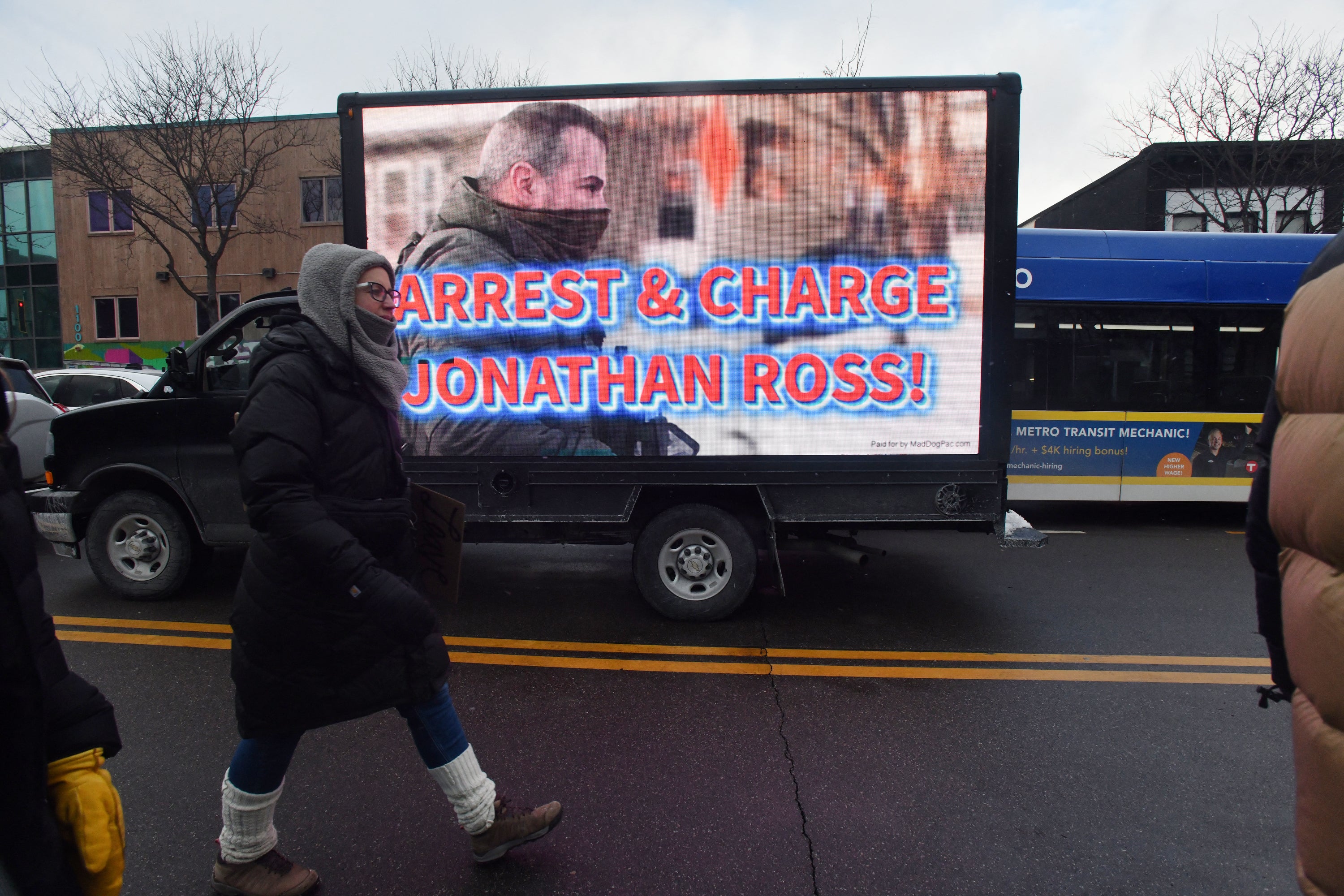 Democratic lawmakers are outraged that immigration agent Jonathan Ross, shown here on an electronic billboard in Minneapolis in January, has been reinstated and reassigned outside Minnesota