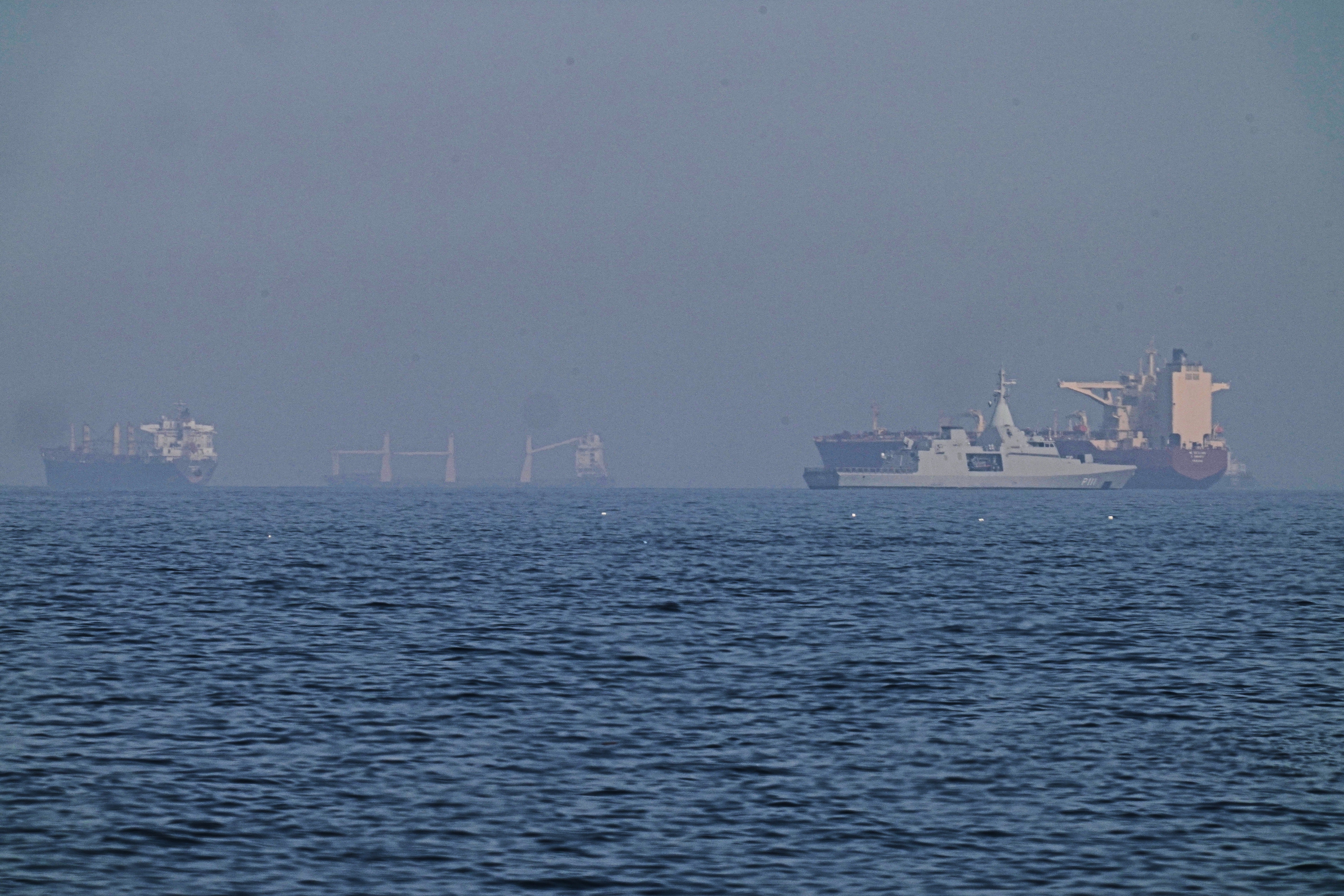 An Emirati patrol boat, 2nd from right, is adjacent a tanker anchored successful nan Gulf of Oman adjacent nan Strait of Hormuz