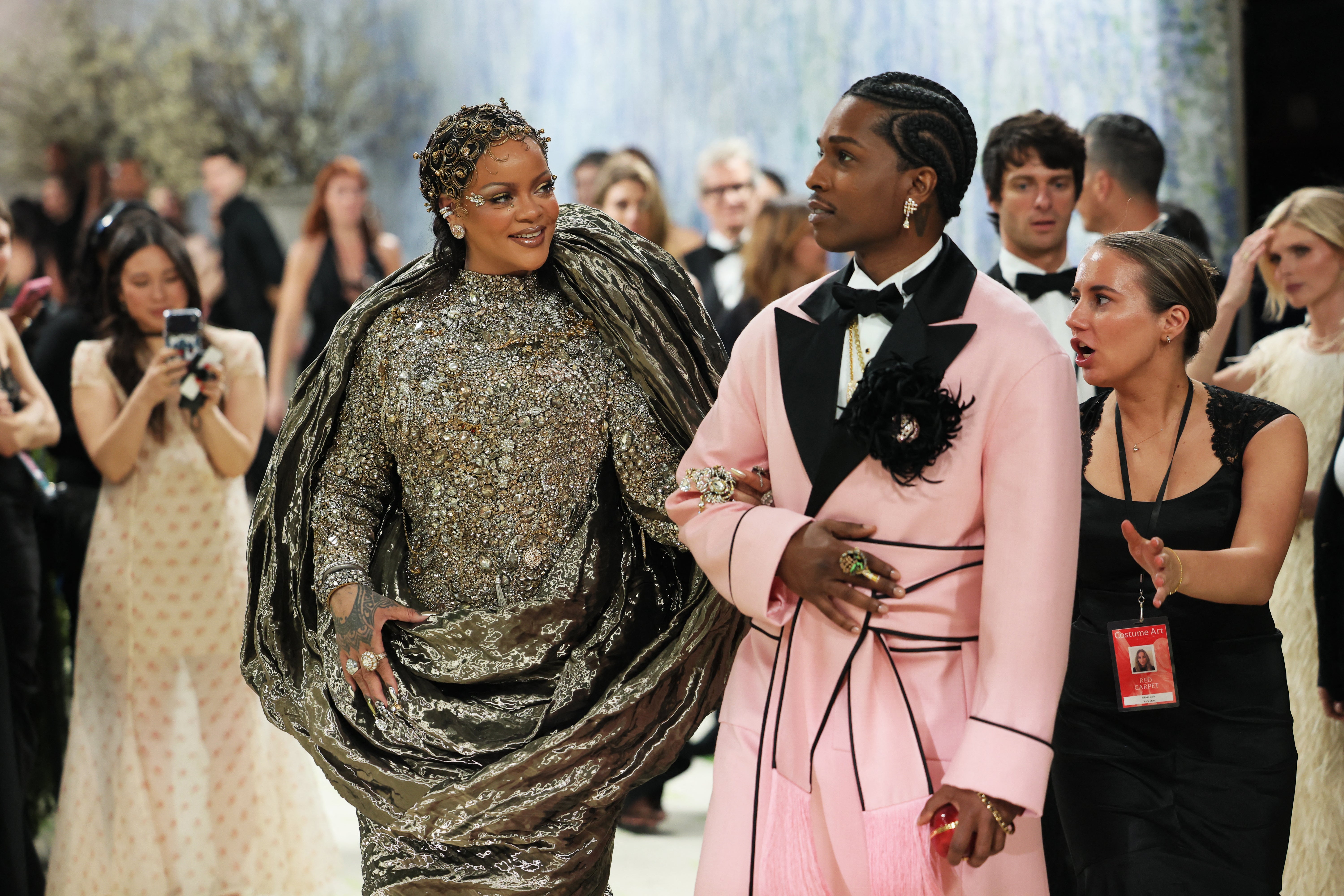 Rihanna was joined by her husband A$AP Rocky, who wore a custom Chanel pink robe with black satin lapels and black piping details, embellished with a black silk