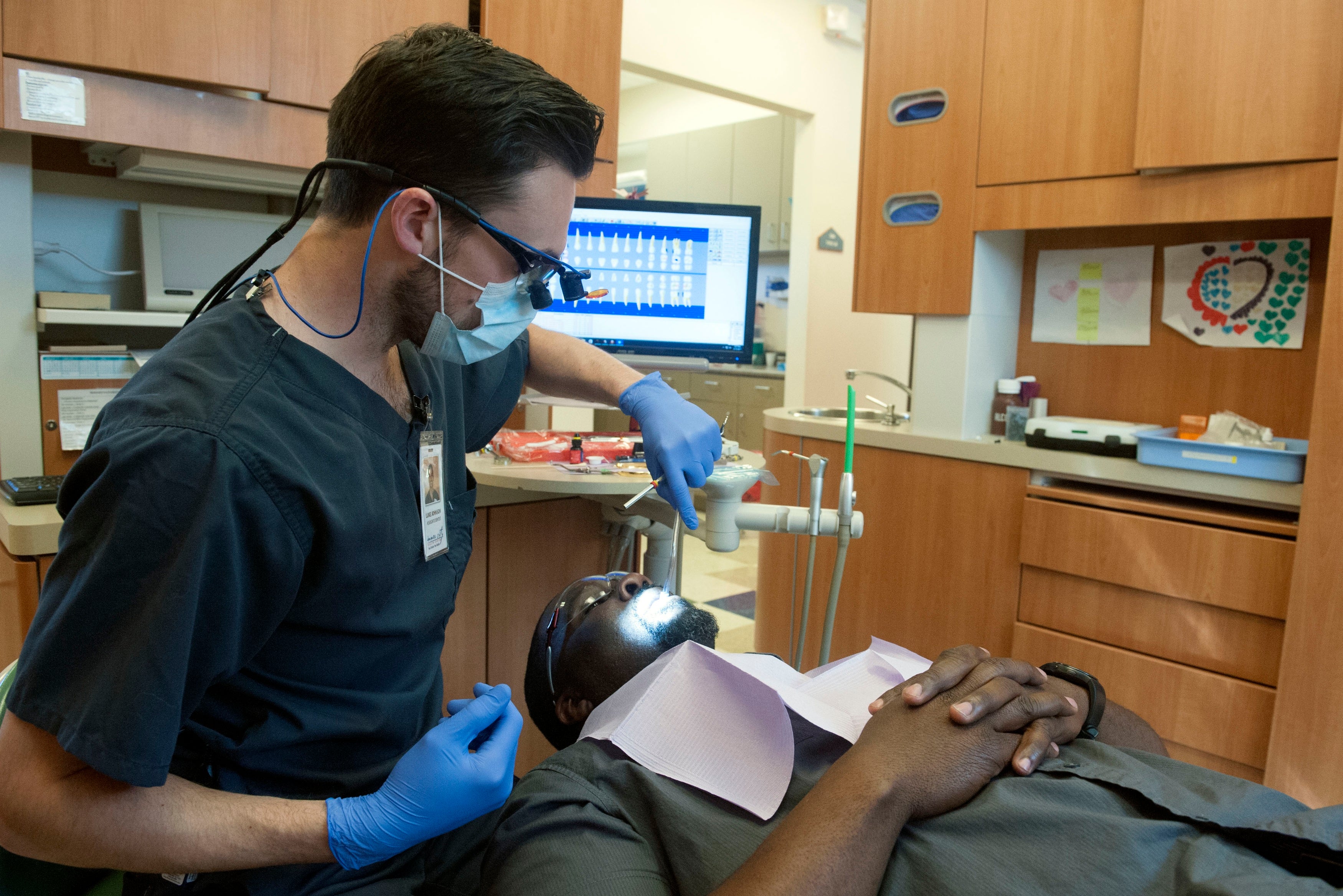 A dentist numbs a patient’s jaw in March 2017 in Denver, Colorado. Waiting to get a filling can result in extreme discomfort