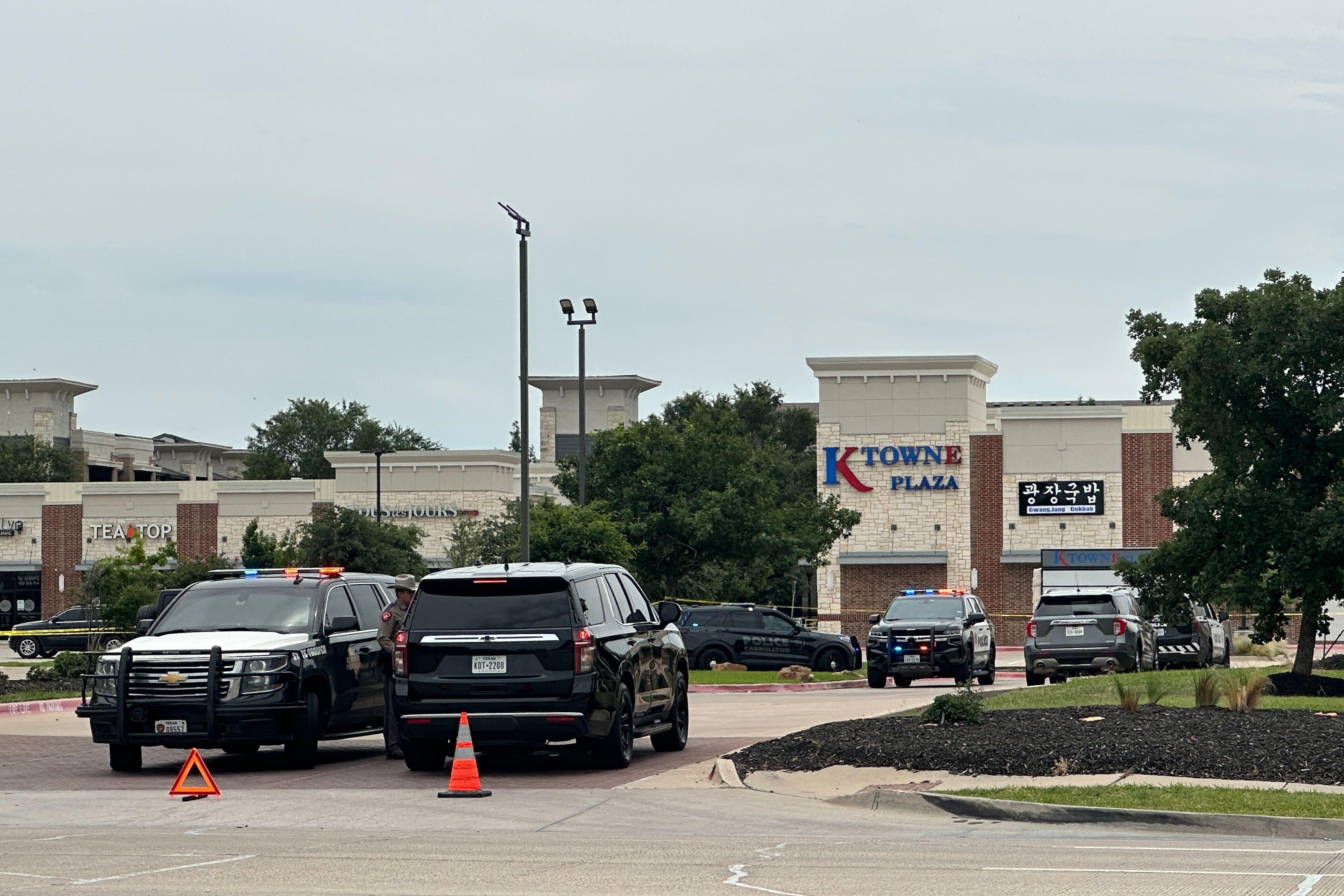 Video posted online showed officers with their guns drawn as they walked past doors at K Towne Plaza in an area of the city known as Koreatown