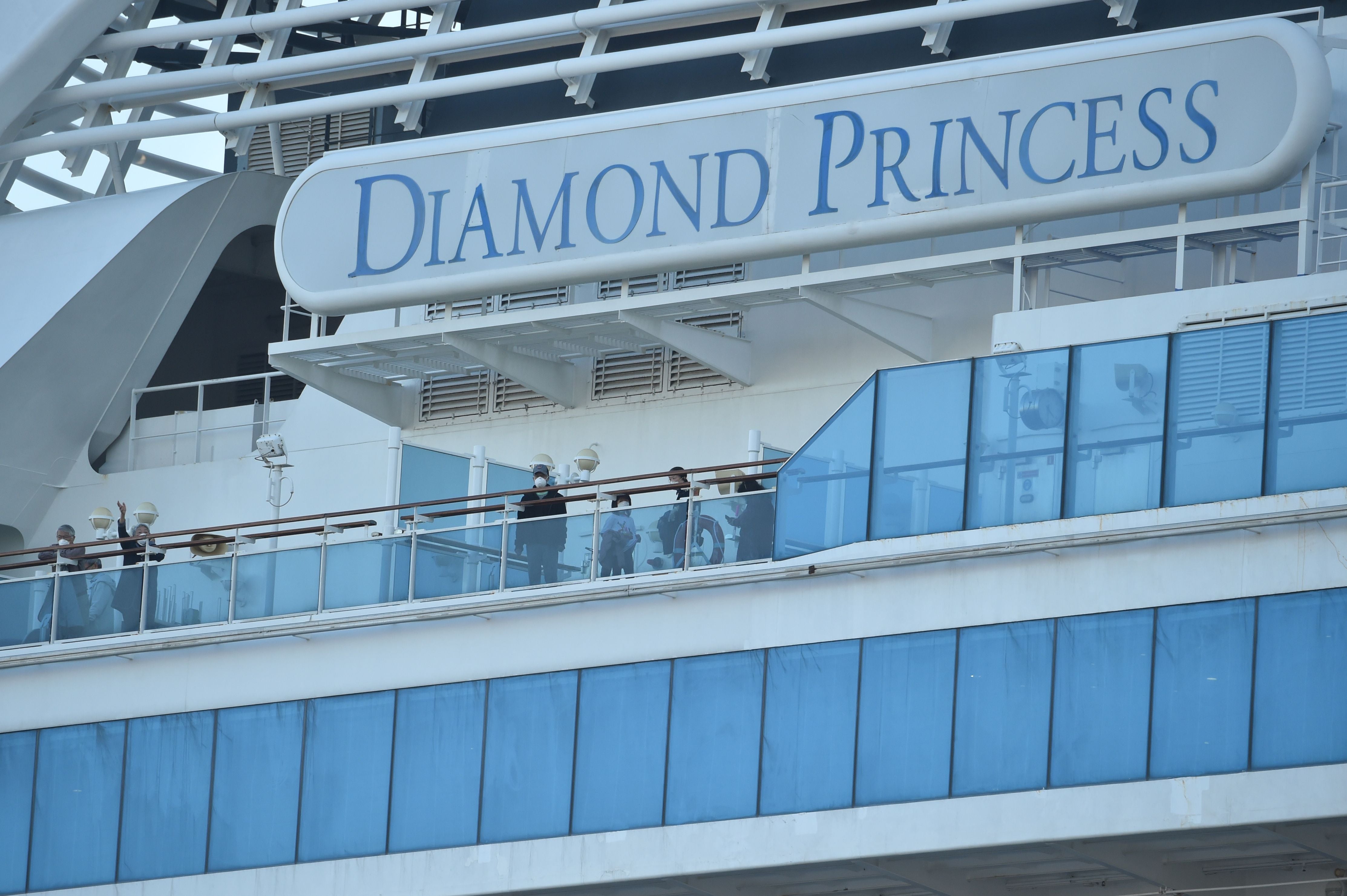 Passengers are seen on the deck of the Diamond Princess cruise ship in February 2020. Hundreds contracted Covid while on the ship, including more than 100 U.S. passengers