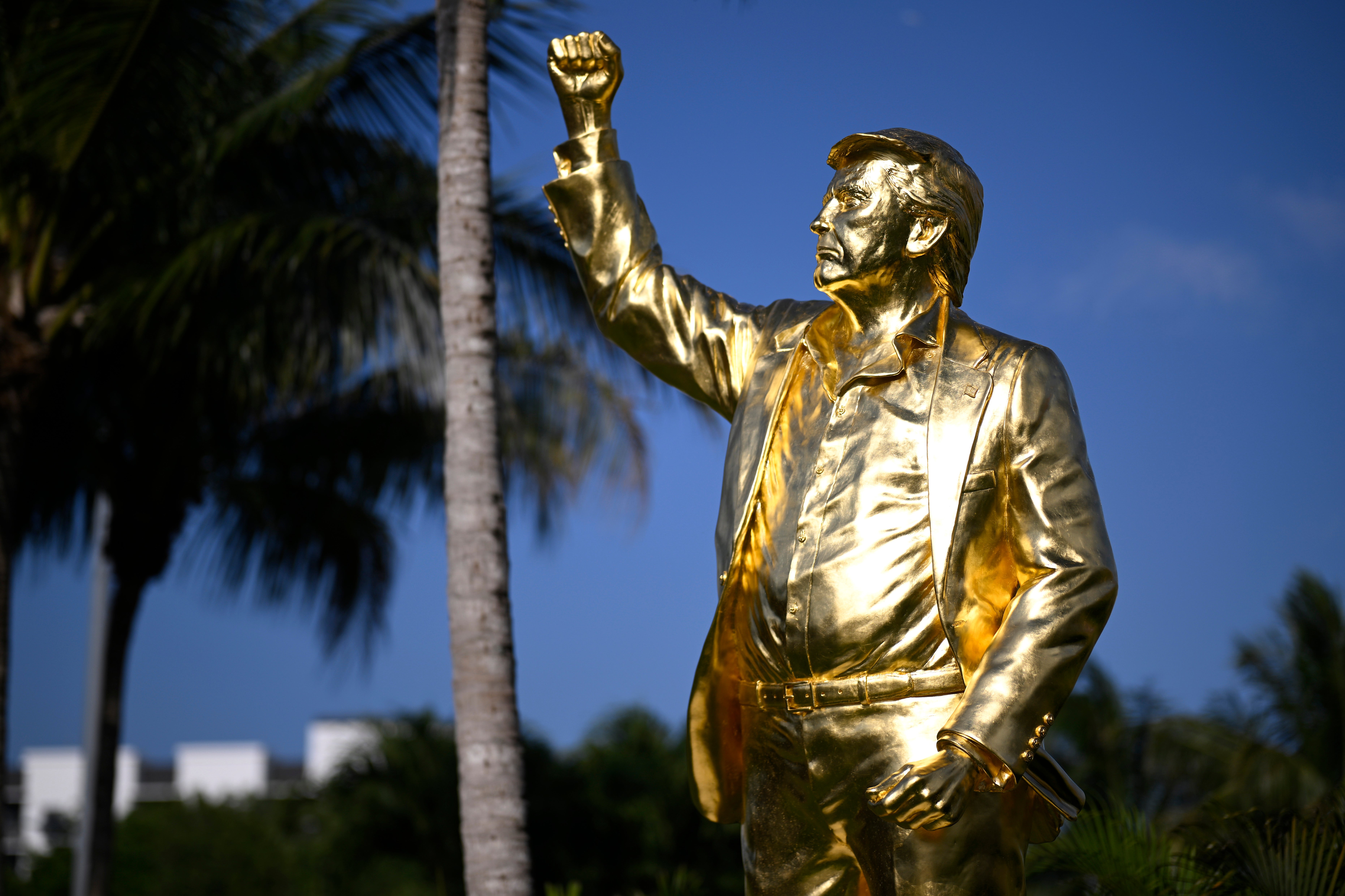 A pastor dedicated a 22-foot golden statue of Donald Trump at his golf course in Florida on Wednesday, saying it 'stands as a reminder of the hand of God and His protection over President Trump’s life'