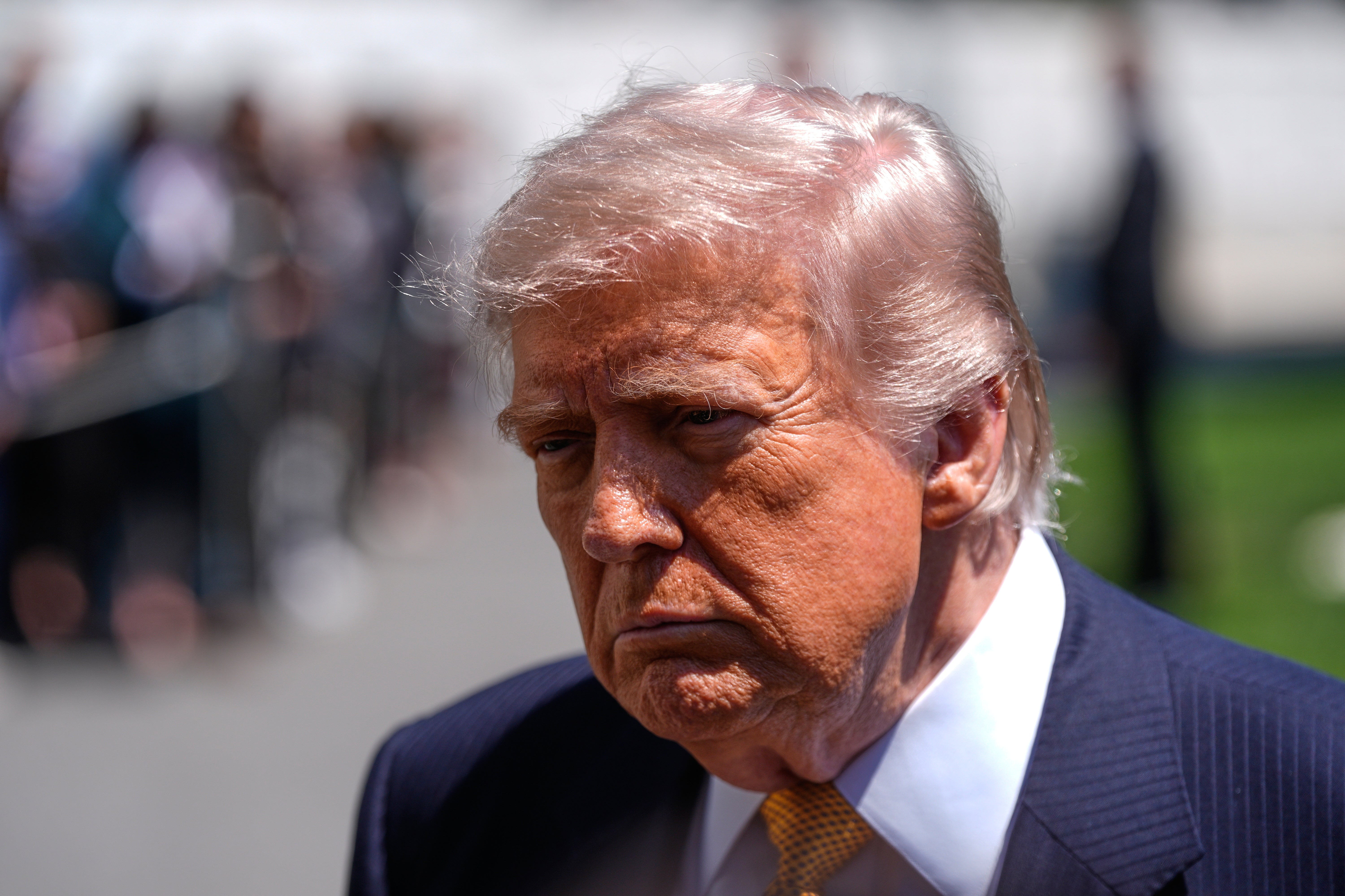 President Donald Trump speaks to reporters as he leaves the White House for travel to Beijing