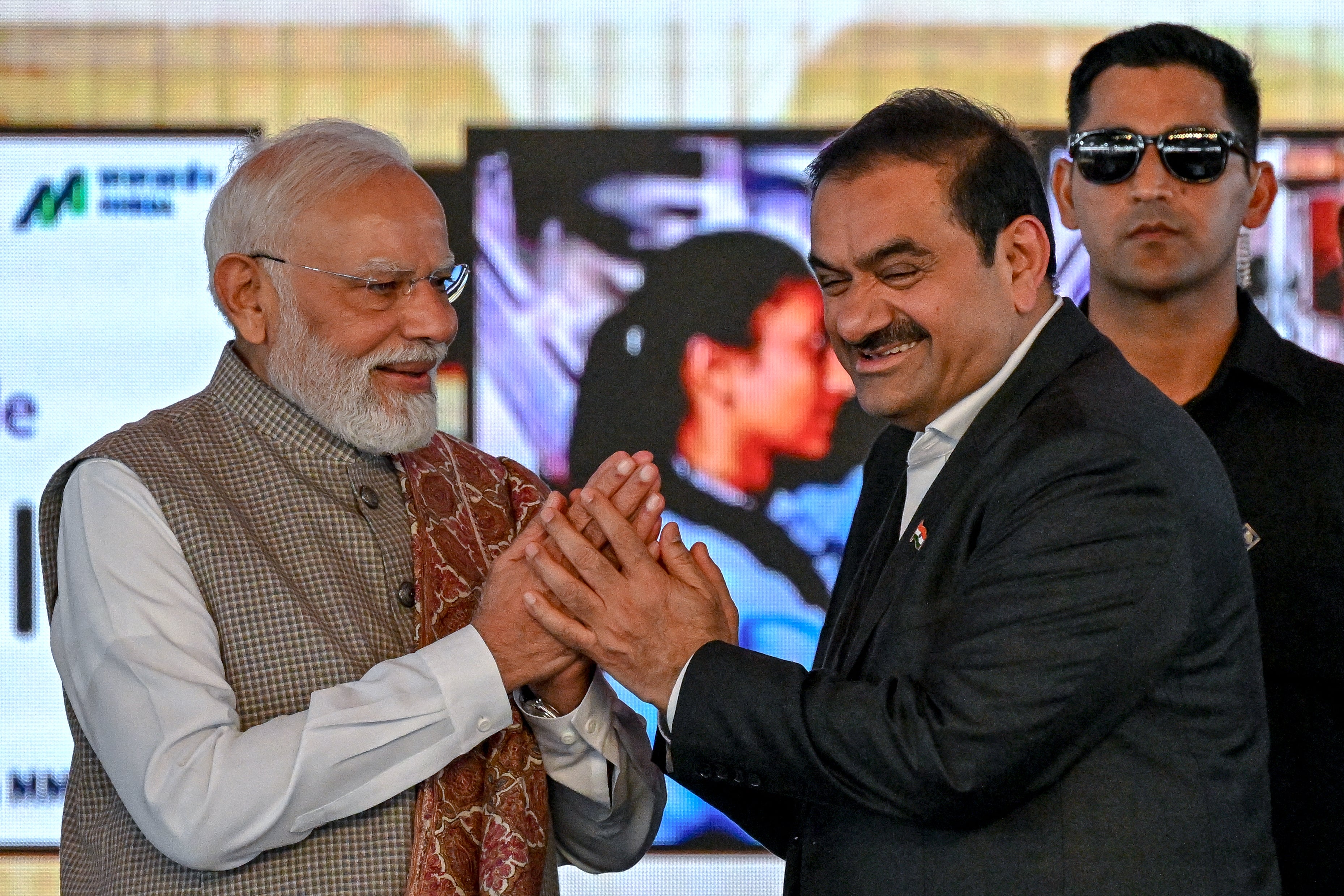 India's prime minister Narendra Modi greets Gautam Adani, chairperson of Indian conglomerate Adani Group, during the inauguration ceremony of phase one of the Navi Mumbai International Airport in Navi Mumbai