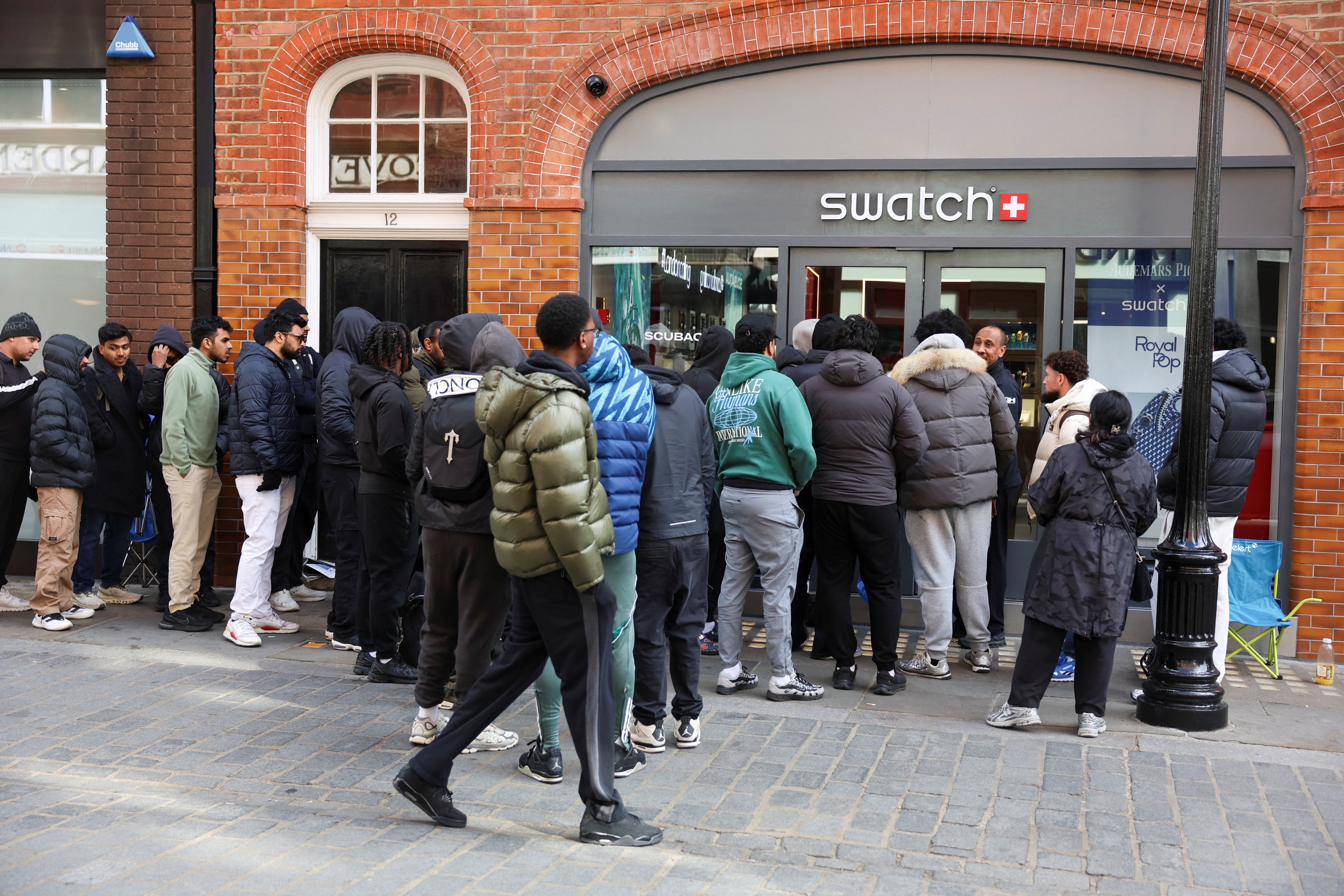 People queue to buy a Swatch limited-edition Royal Pop watch in London