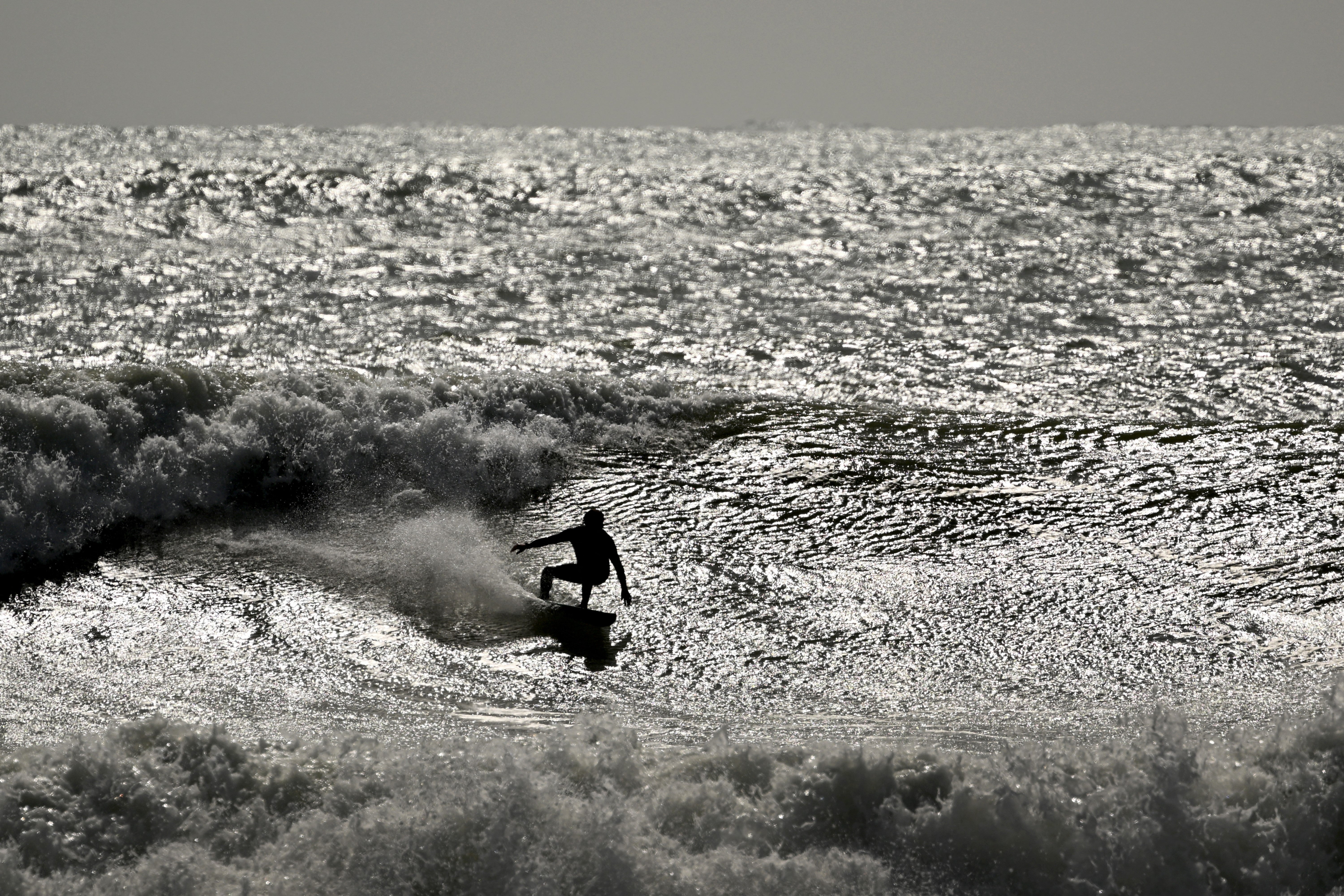 A surfer cuts up a wave during rough conditions at Manu Bay