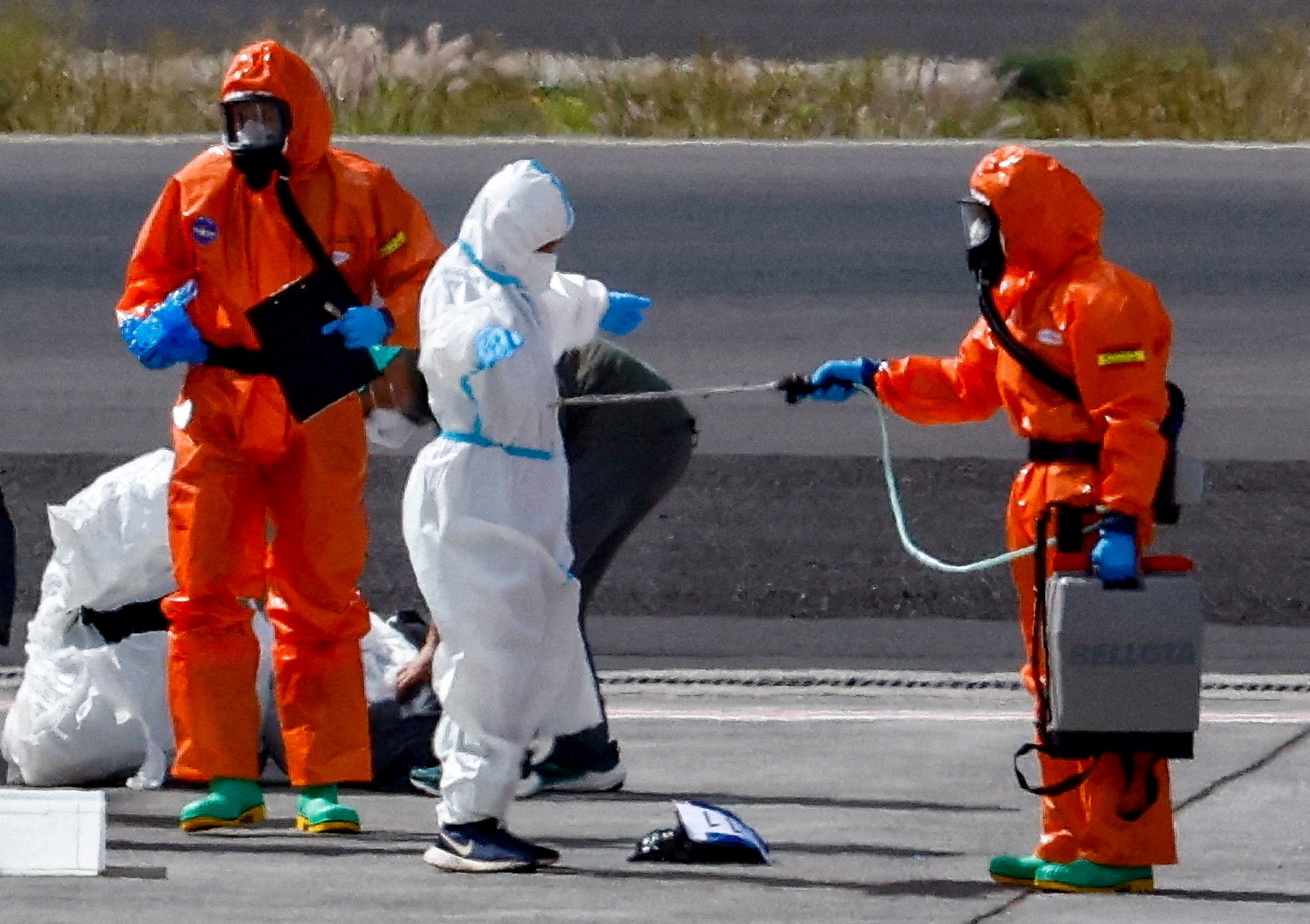 <p>A passenger of the cruise ship MV Hondius, which was affected by a deadly hantavirus outbreak, is disinfected on the tarmac at Tenerife Sud airport in the Spanish Canary Islands earlier this month. The world’s top health leader says that the outbreak is ‘stable for now’</p>