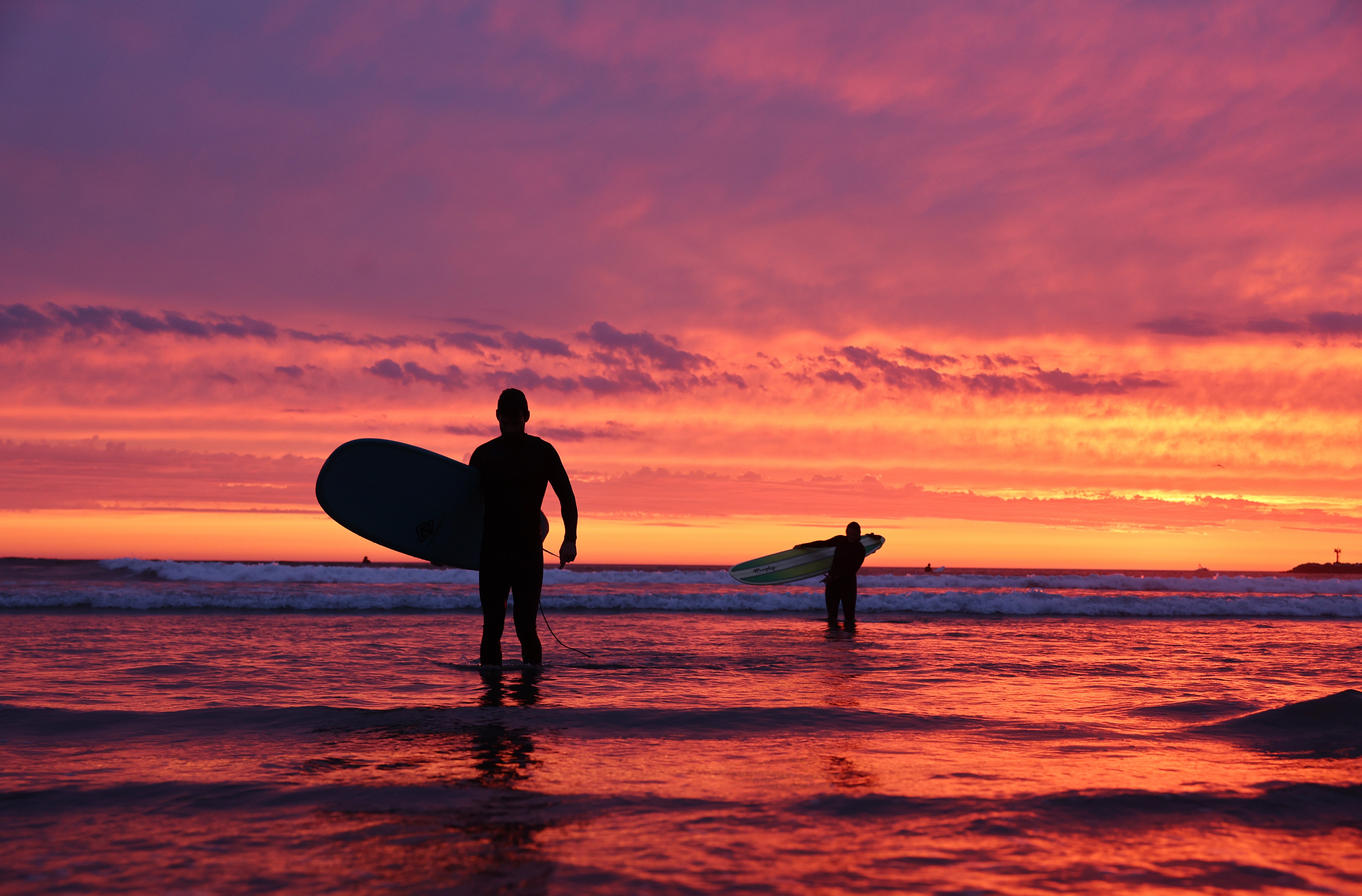 <p>Surfers walk out of the waters at Ocean Beach in San Diego, California, in August 2023. This summer season expected to be the longest of the next decade</p>