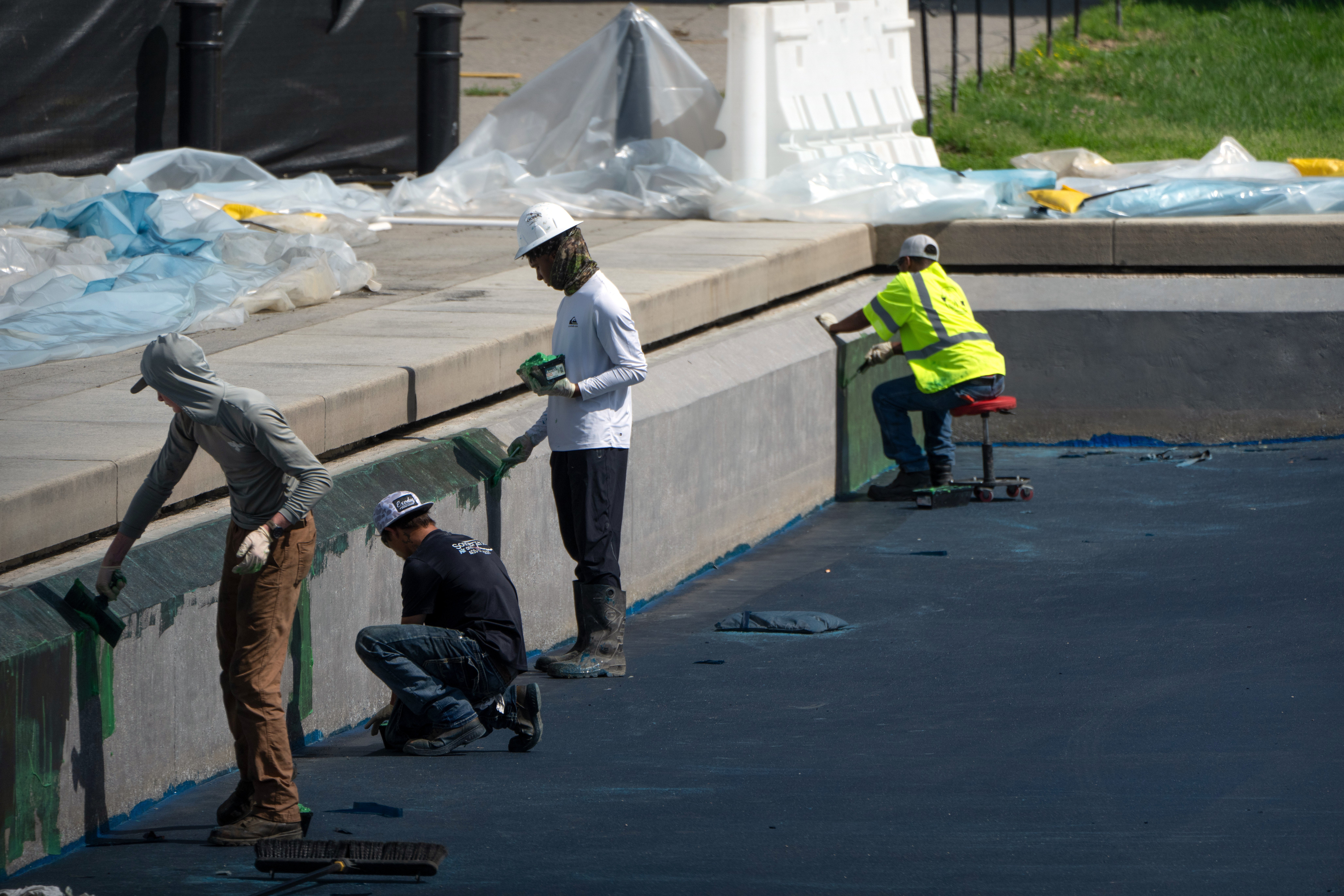 Money from nationalist parks passes is paying for a renewal of nan Lincoln Memorial Reflecting Pool, wherever workers are seen applying a bluish coating