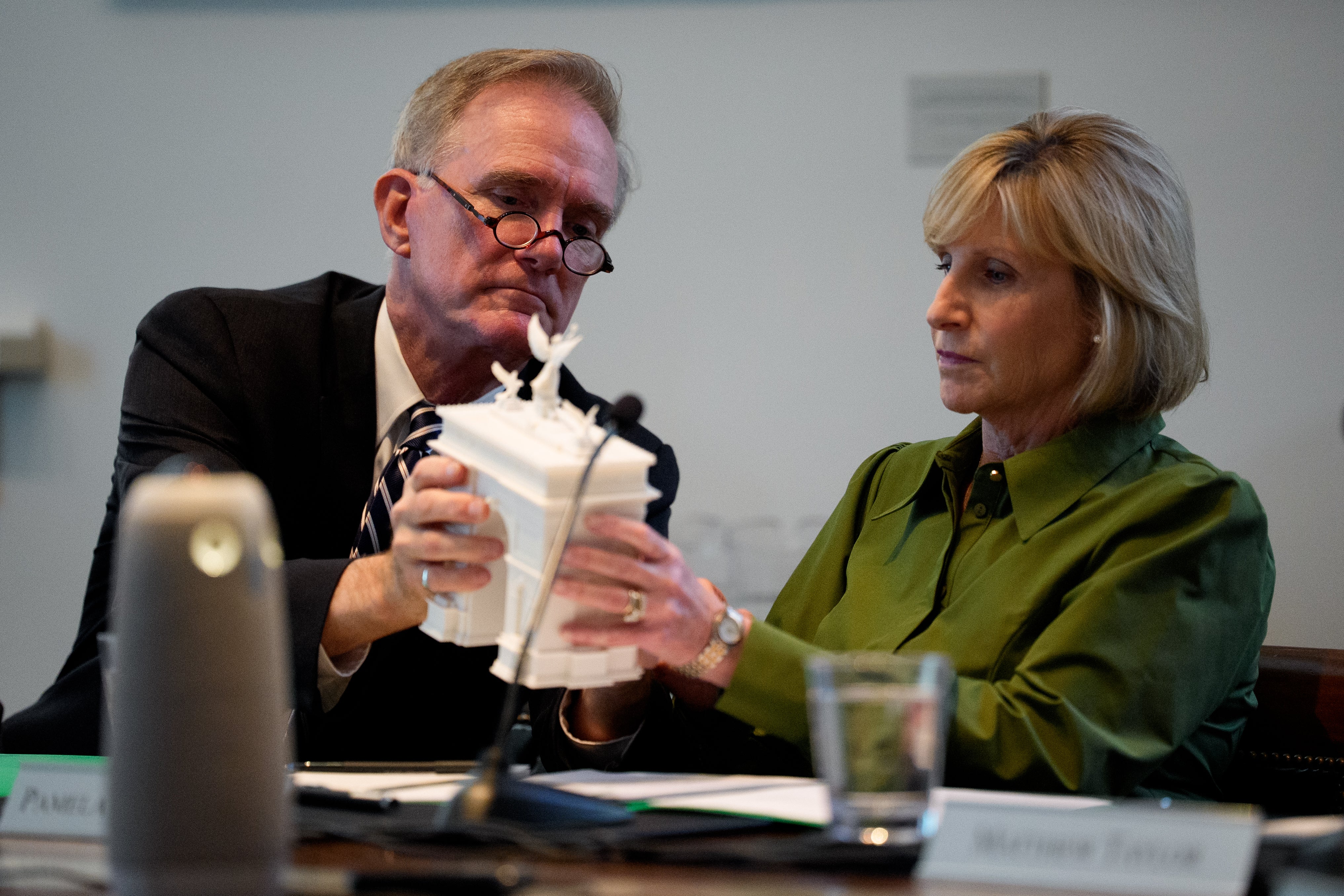 At slightest 1 lawmaker has raised concerns astir nan effect nan arch could person connected traffic. Pictured here, Commission of Fine Arts Chairman Rodney Mims Cook Jr., (L) hands Pamela Hughes Patenaude (R) a exemplary of President Donald Trump's projected triumphal arch connected April 16