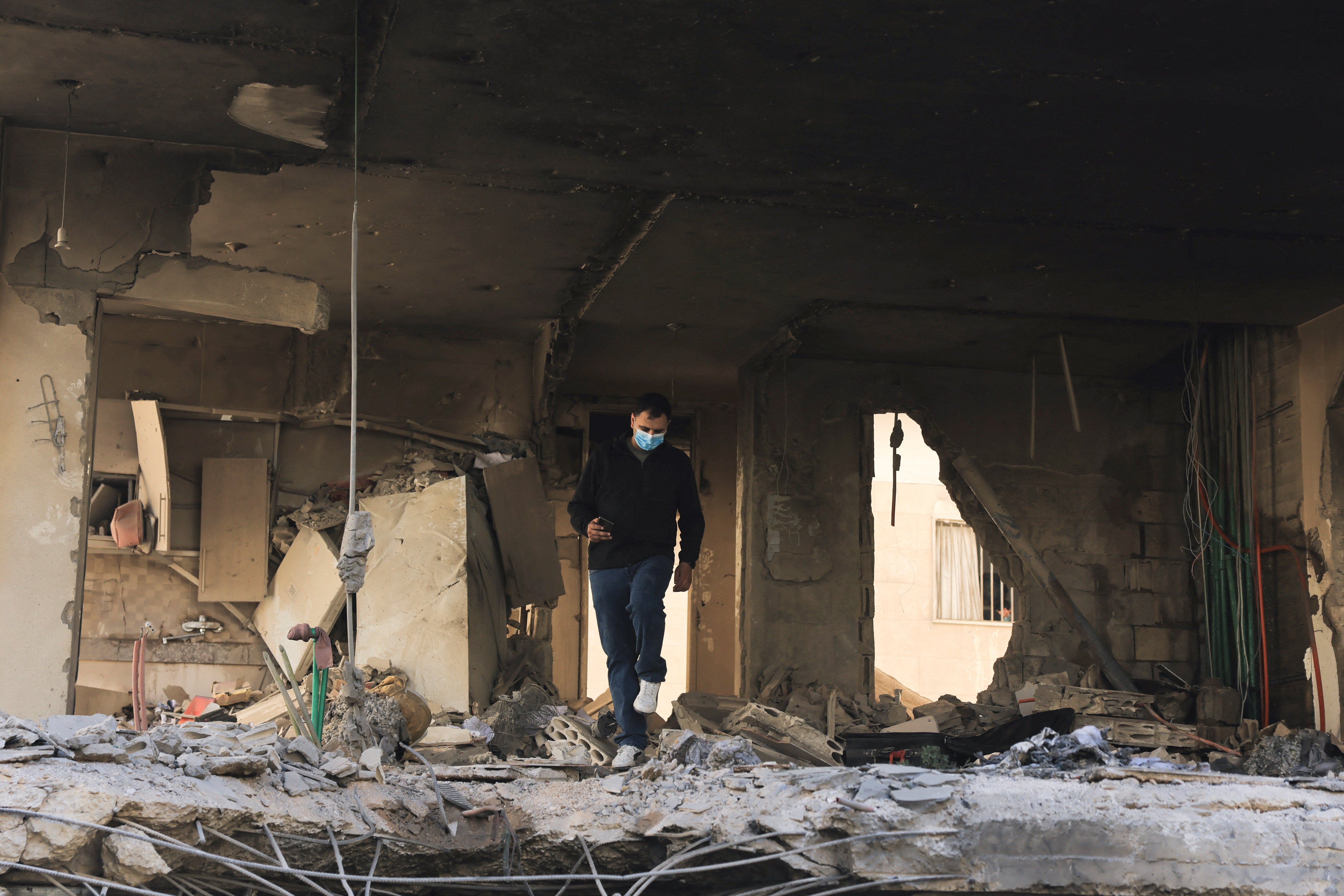 A man walks done a damaged building astatine nan tract of an Israeli onslaught connected Beirut's confederate suburbs, Lebanon, May 28, 2026.