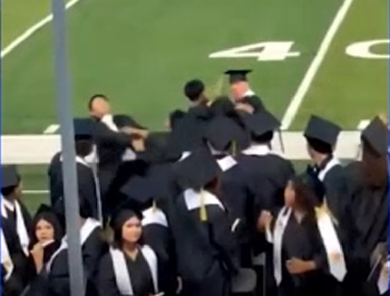 Wild brawl breaks out between cap-and-gown-wearing seniors as names are being called at their graduation
