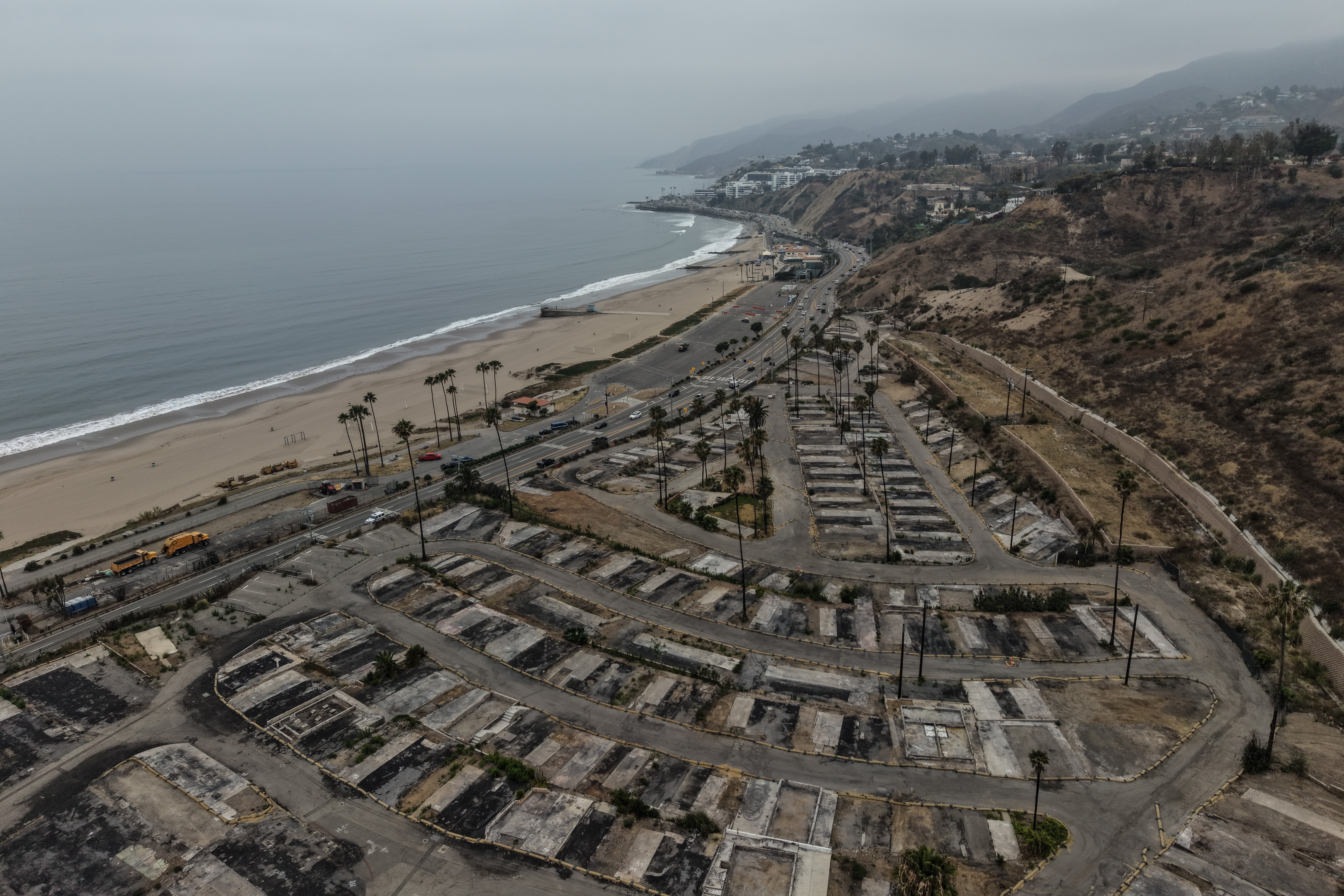 An aerial view shows the cleared site of a mobile home in the Palisades