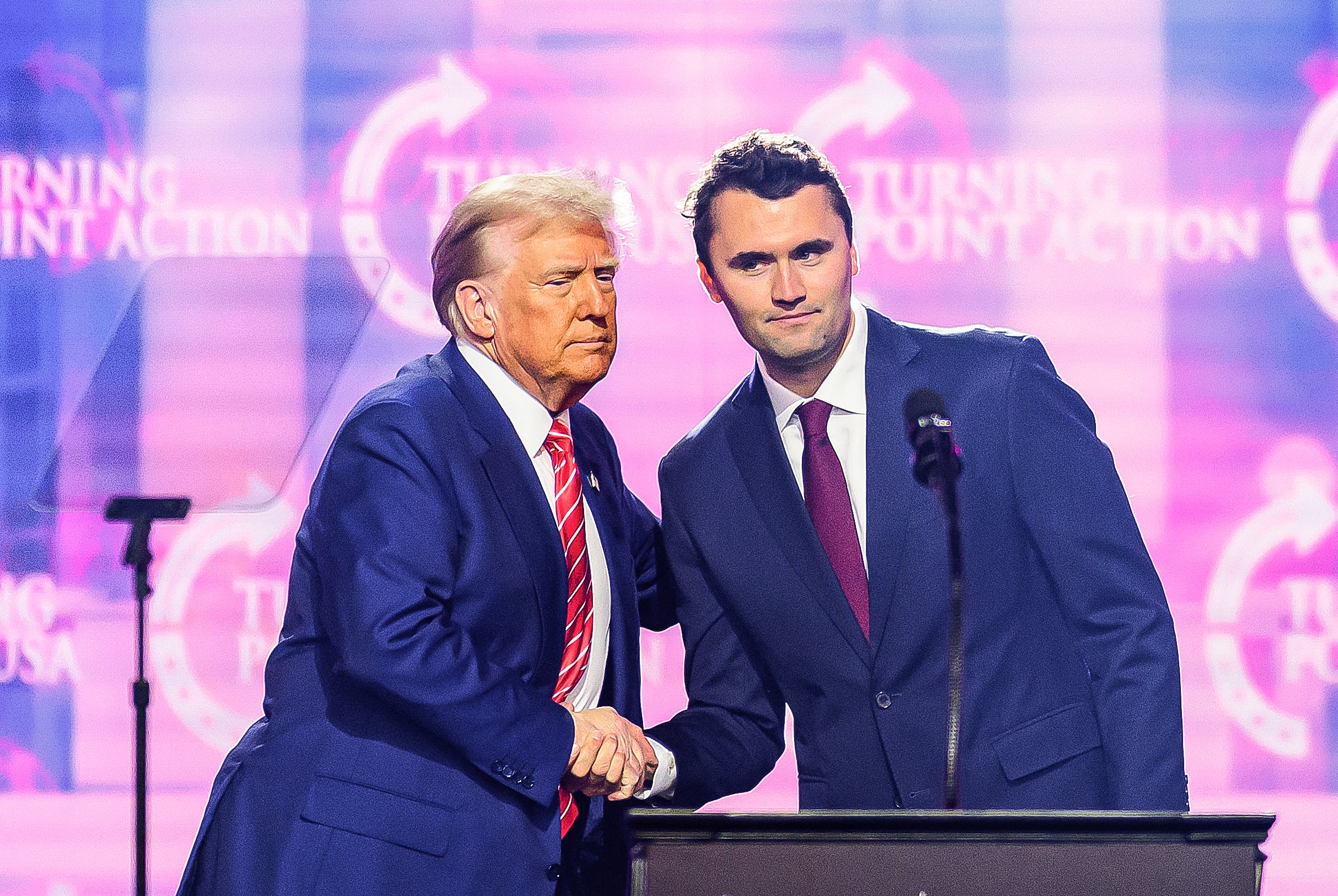 This photograph taken connected December 22, 2024 shows right-wing activistic Charlie Kirk (R) shaking hands pinch US President Donald Trump arsenic he speaks connected shape astatine America Fest 2024 successful Phoenix
