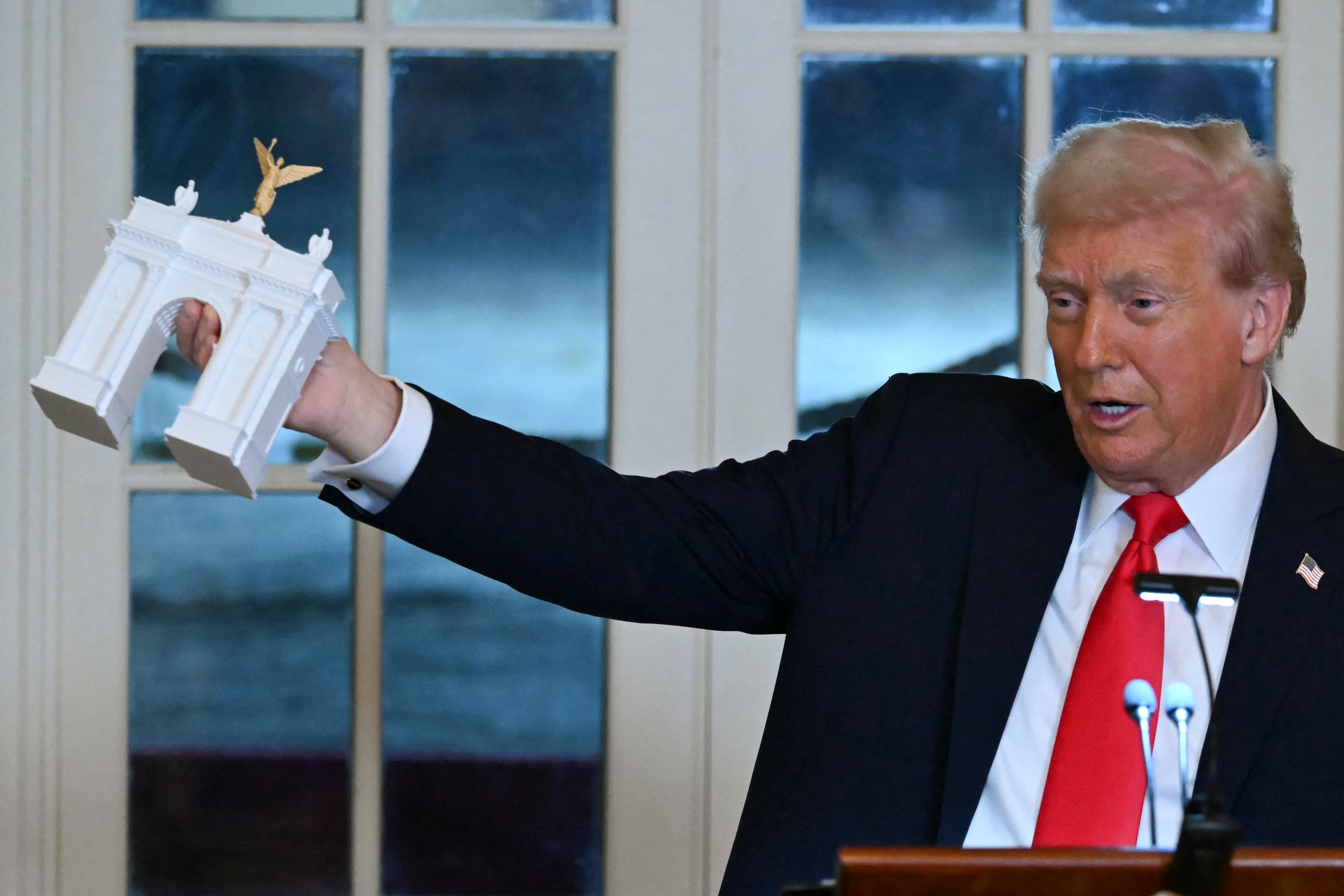 President Donald Trump holding up a exemplary of his projected arch. A apical Democrat is now calling connected nan FAA to cull plans for nan project